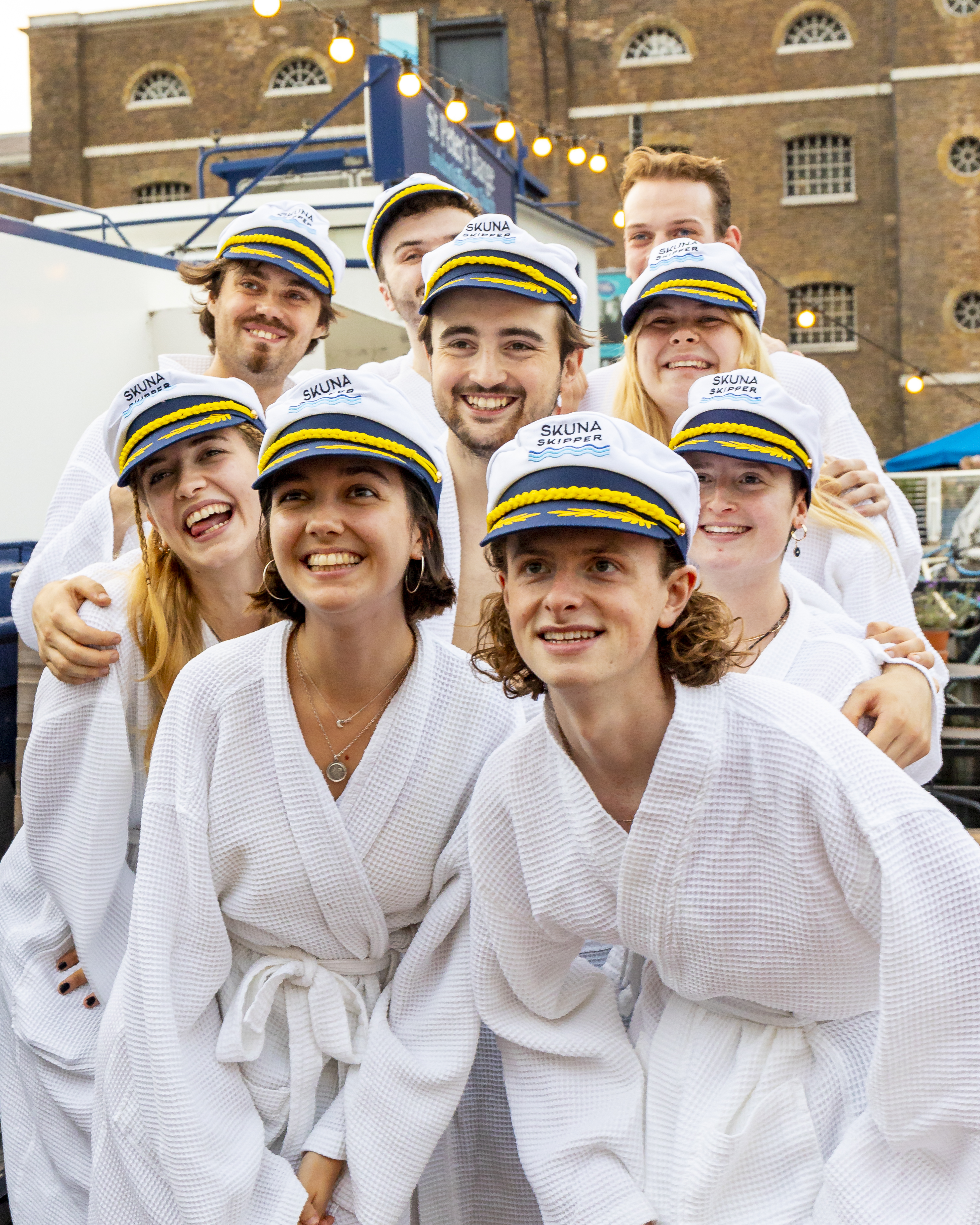 Hot Tub Boat with young professionals in nautical attire at a team-building event.