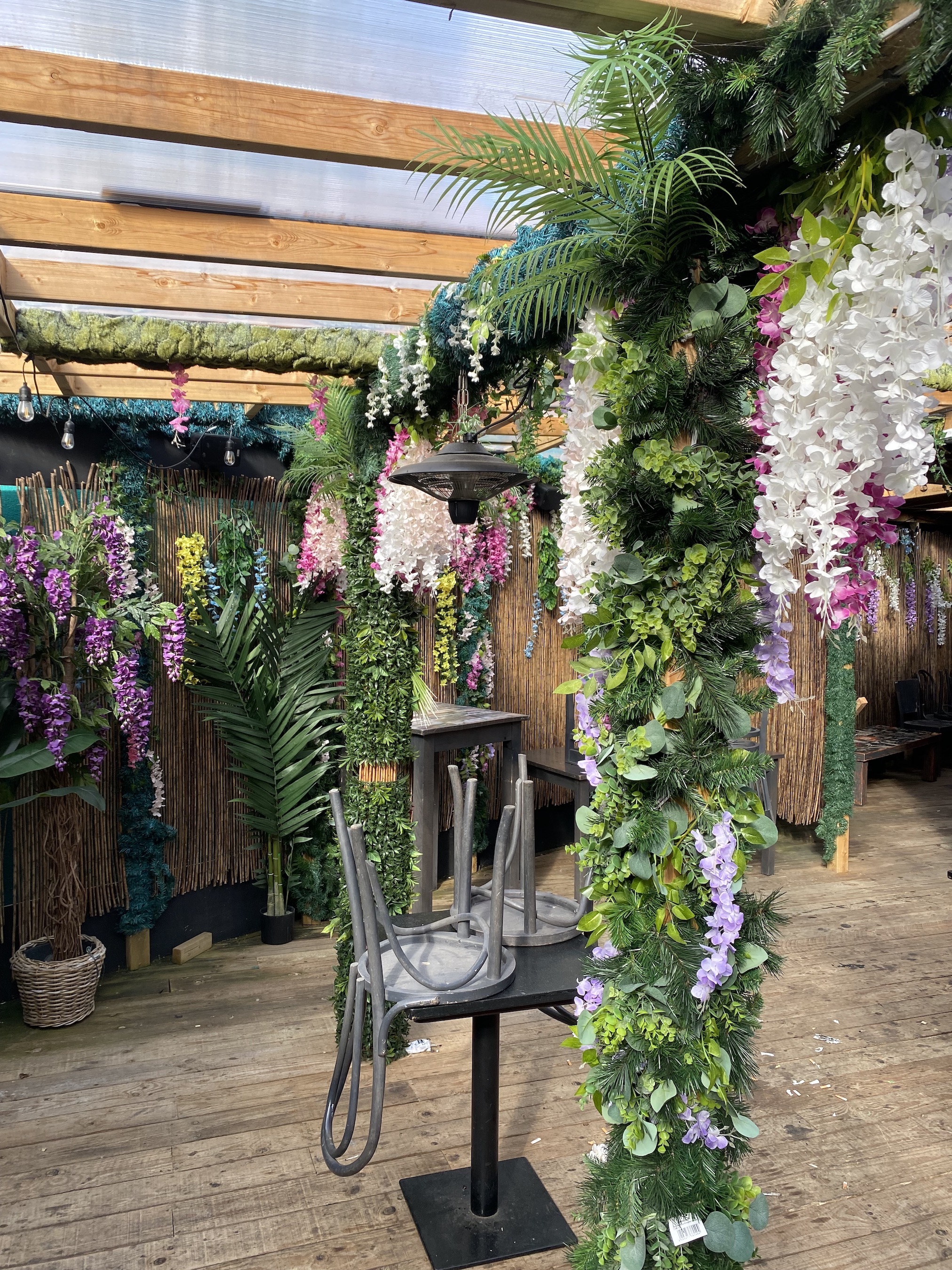 Vibrant event space with artificial flowers for tropical-themed gatherings.