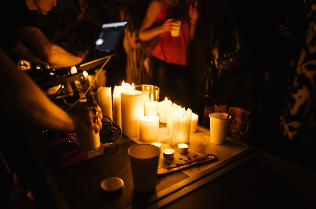 Vibrant lounge event with DJ setup and candlelight ambiance for networking.