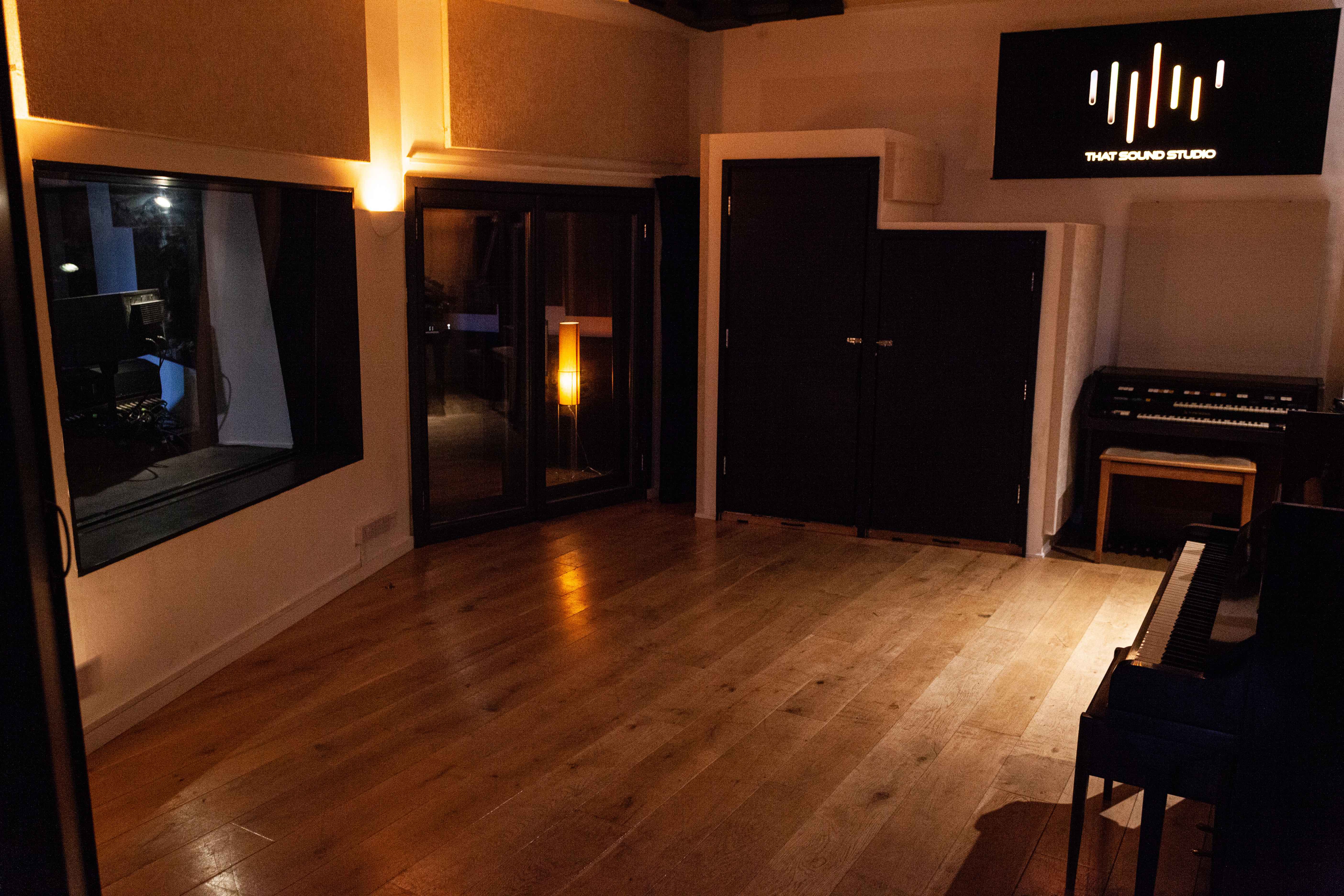 Modern recording studio with warm lighting, ideal for corporate events and creative workshops.