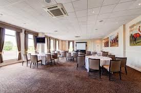 Newmarket Racecourse meeting room with round tables, ideal for conferences and workshops.