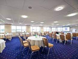 Huntingdon Racecourse meeting room with round tables, perfect for conferences and workshops.