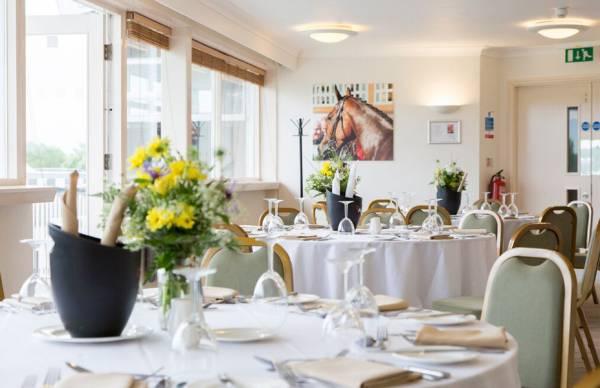 Elegant event space with round tables for corporate meetings in Market Rasen Racecourse.