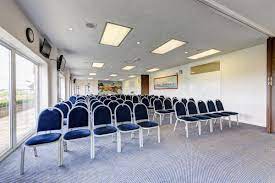 Meetings space with blue chairs at Wincanton Racecourse, ideal for workshops and presentations.