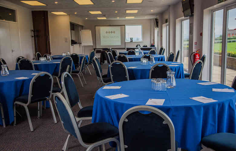 Meetings room at Wincanton Racecourse with blue tablecloths, ideal for workshops and conferences.