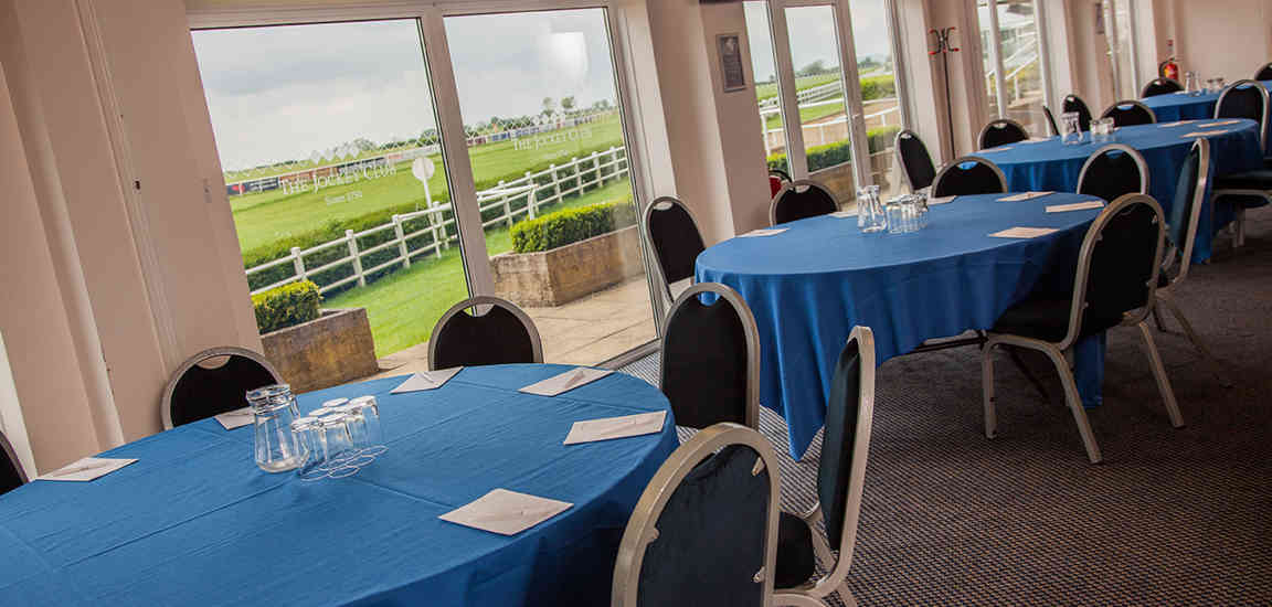 Meetings at Wincanton Racecourse with blue tablecloths and scenic views.