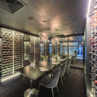Private dining room in Manchester with wine wall, ideal for corporate events and gatherings.
