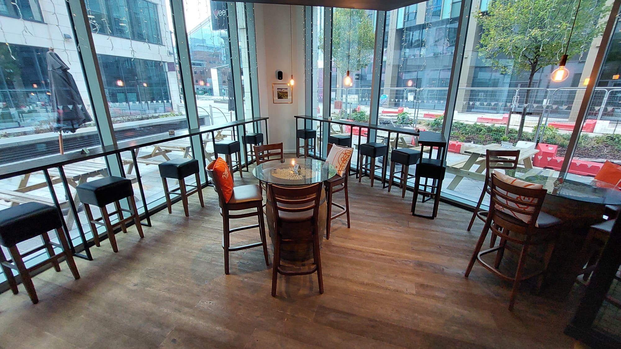 Modern meeting space with round glass table at Veeno Italian Wine Bar, Leeds.