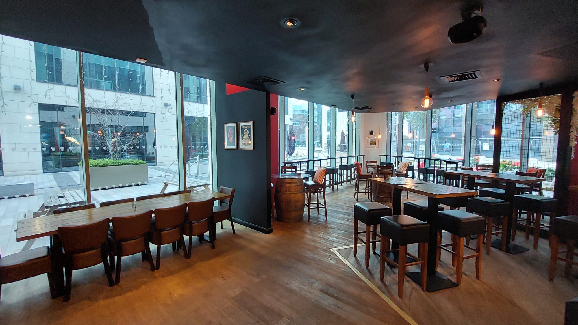 Semi-private event space with large windows at Veeno Italian Wine Bar Leeds, ideal for gatherings.