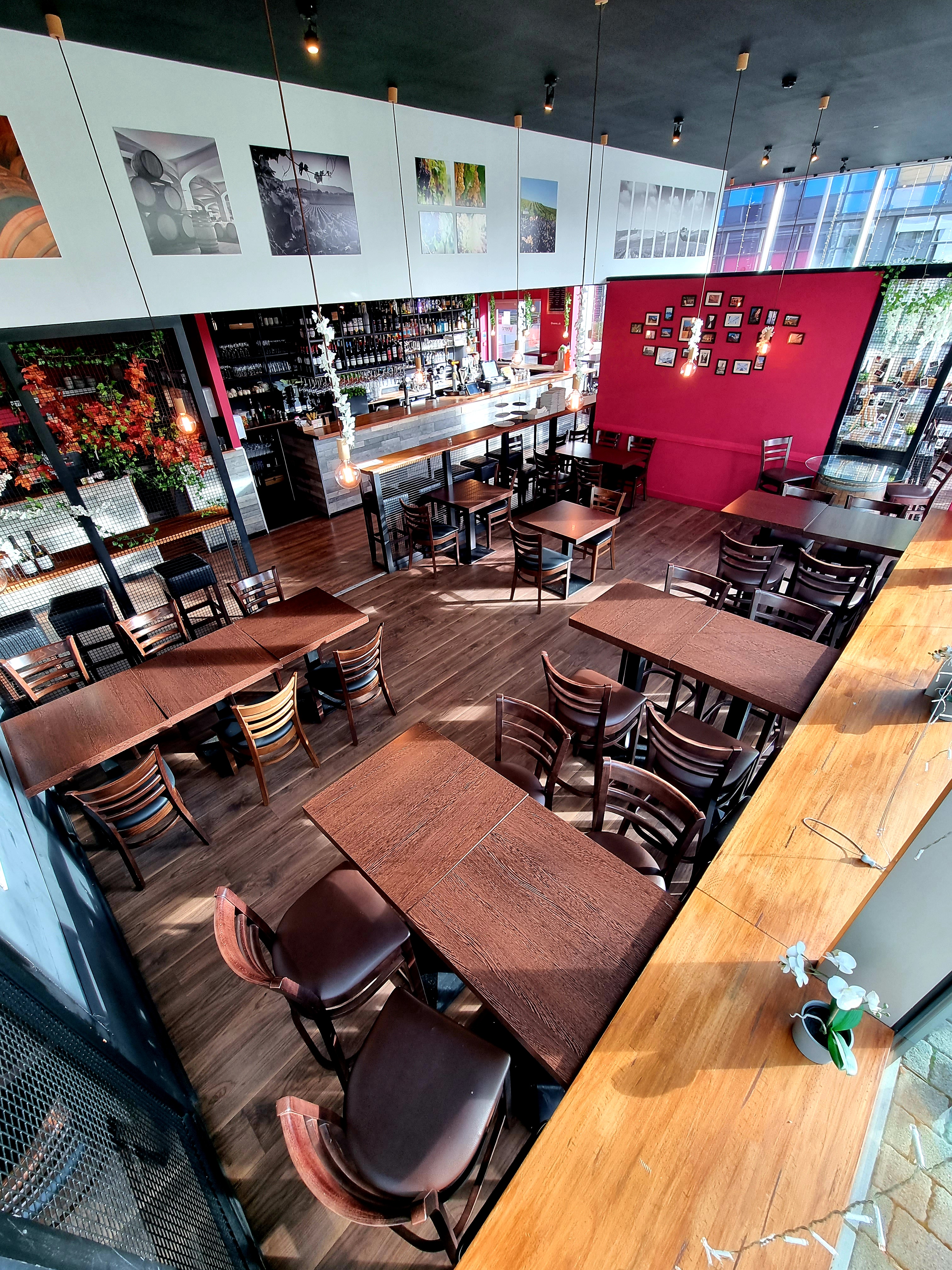 Semi-private hire event space with wooden tables at Veeno Italian Wine Bar, Bristol.