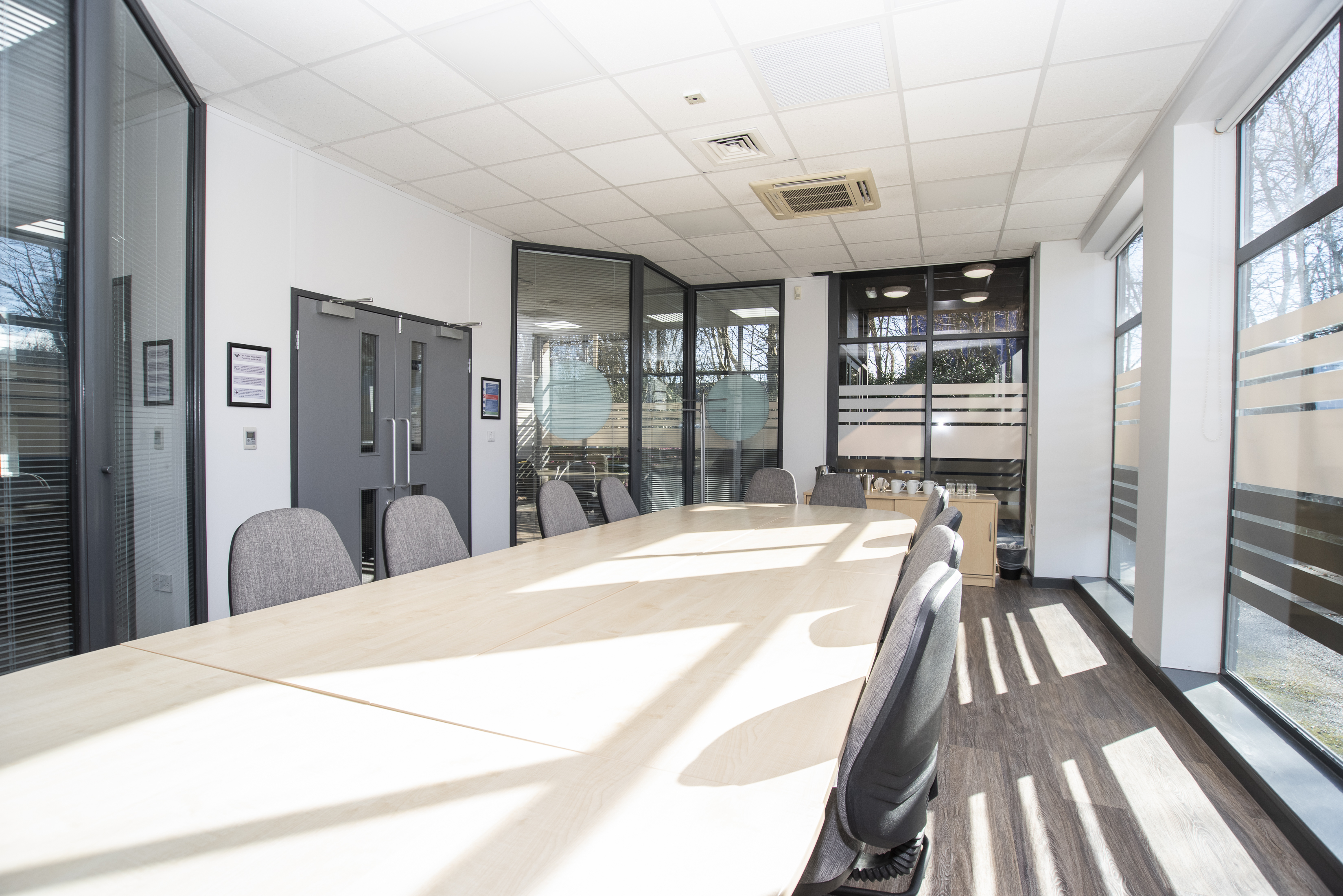 Modern conference room with spacious table and natural light for meetings and events.