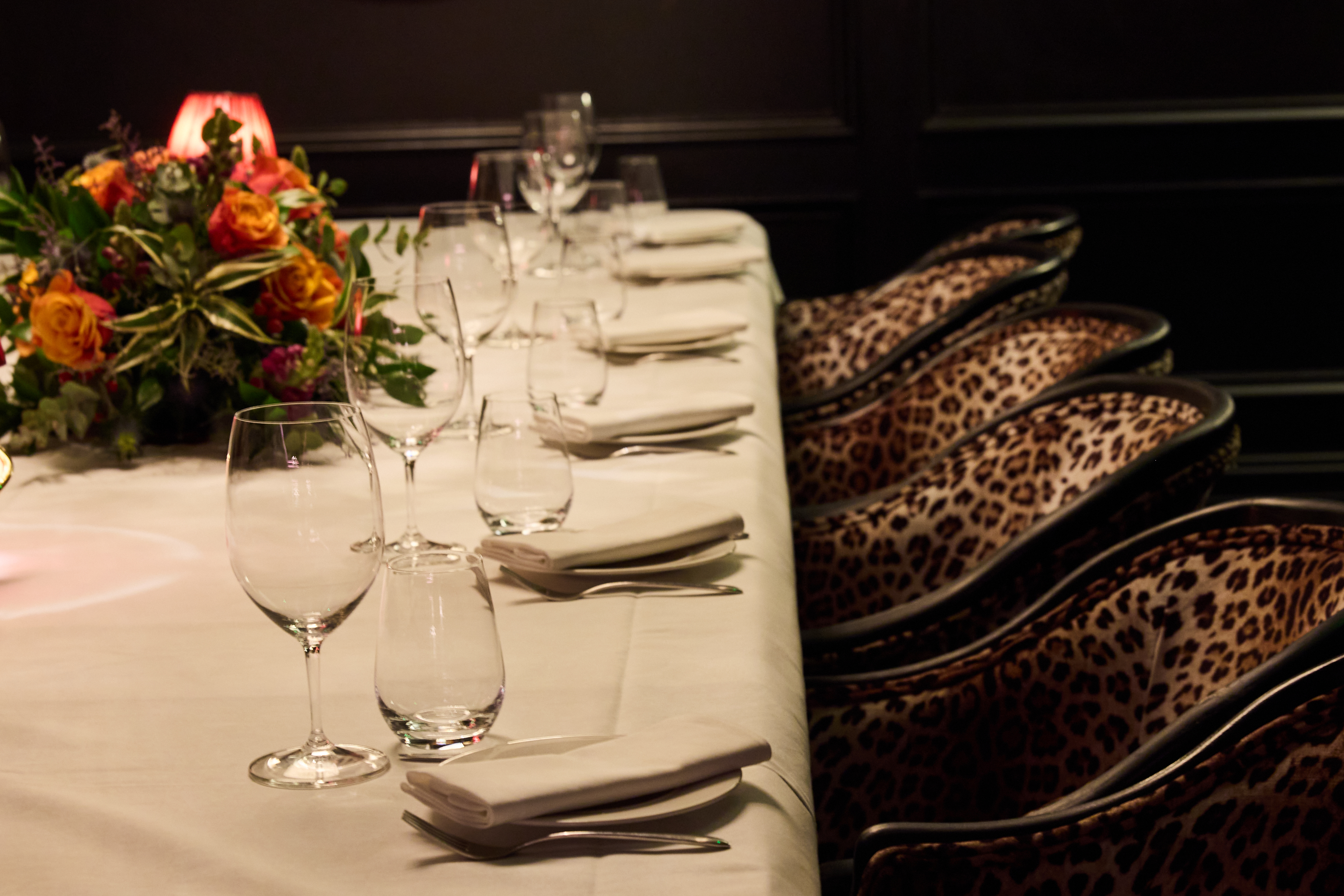 Private dining room with elegant table setting, floral centerpiece for upscale events.