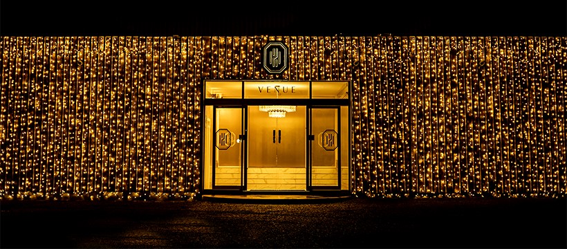 Elegant venue entrance with twinkling lights for upscale events and celebrations.
