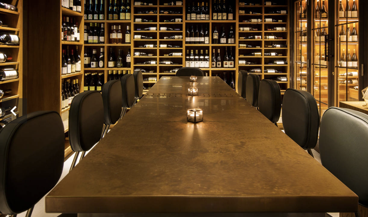Sophisticated private dining space with polished table for corporate dinners and events.