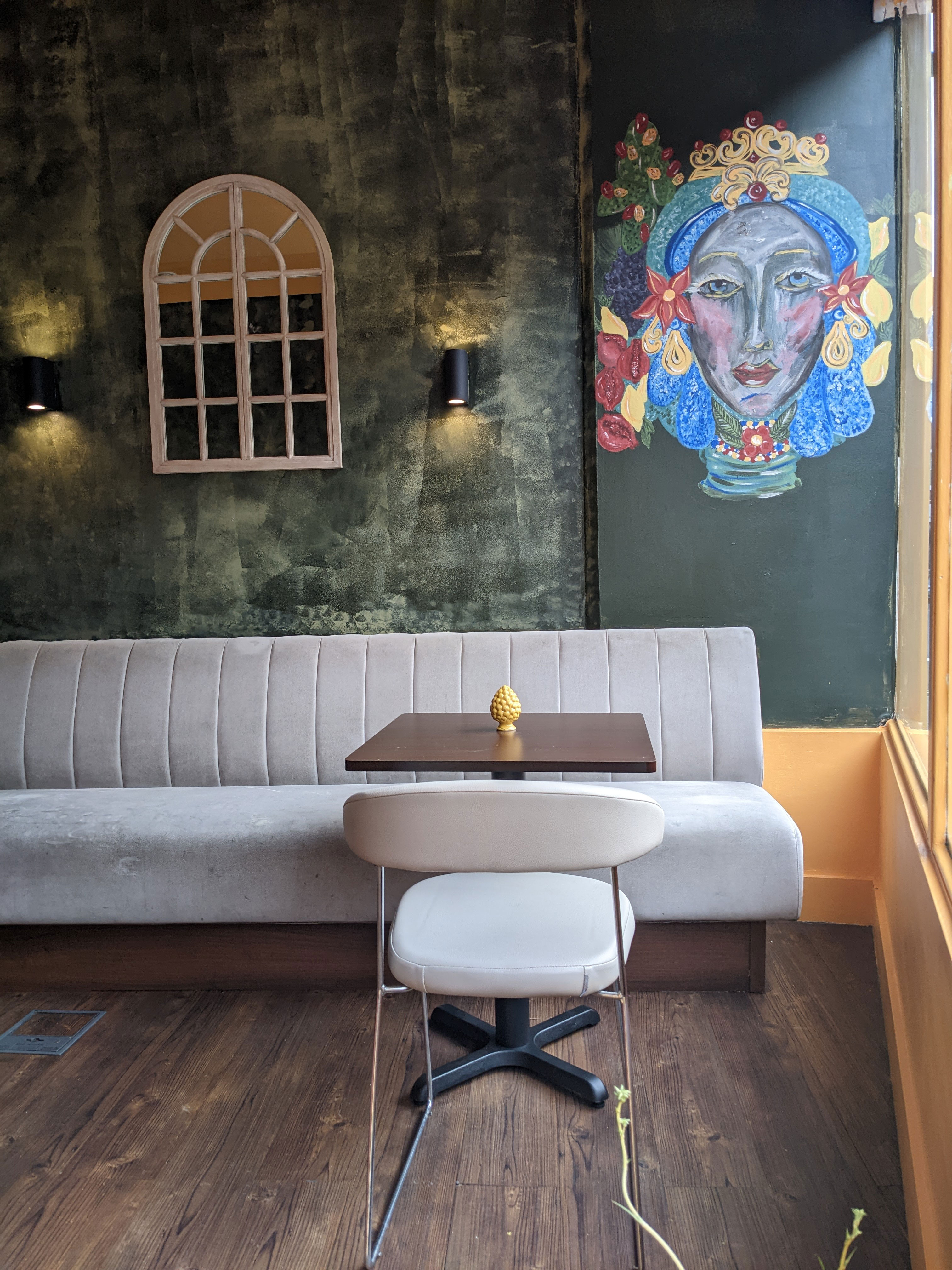 Cozy Sicilian bistro with plush seating, perfect for intimate meetings and events.