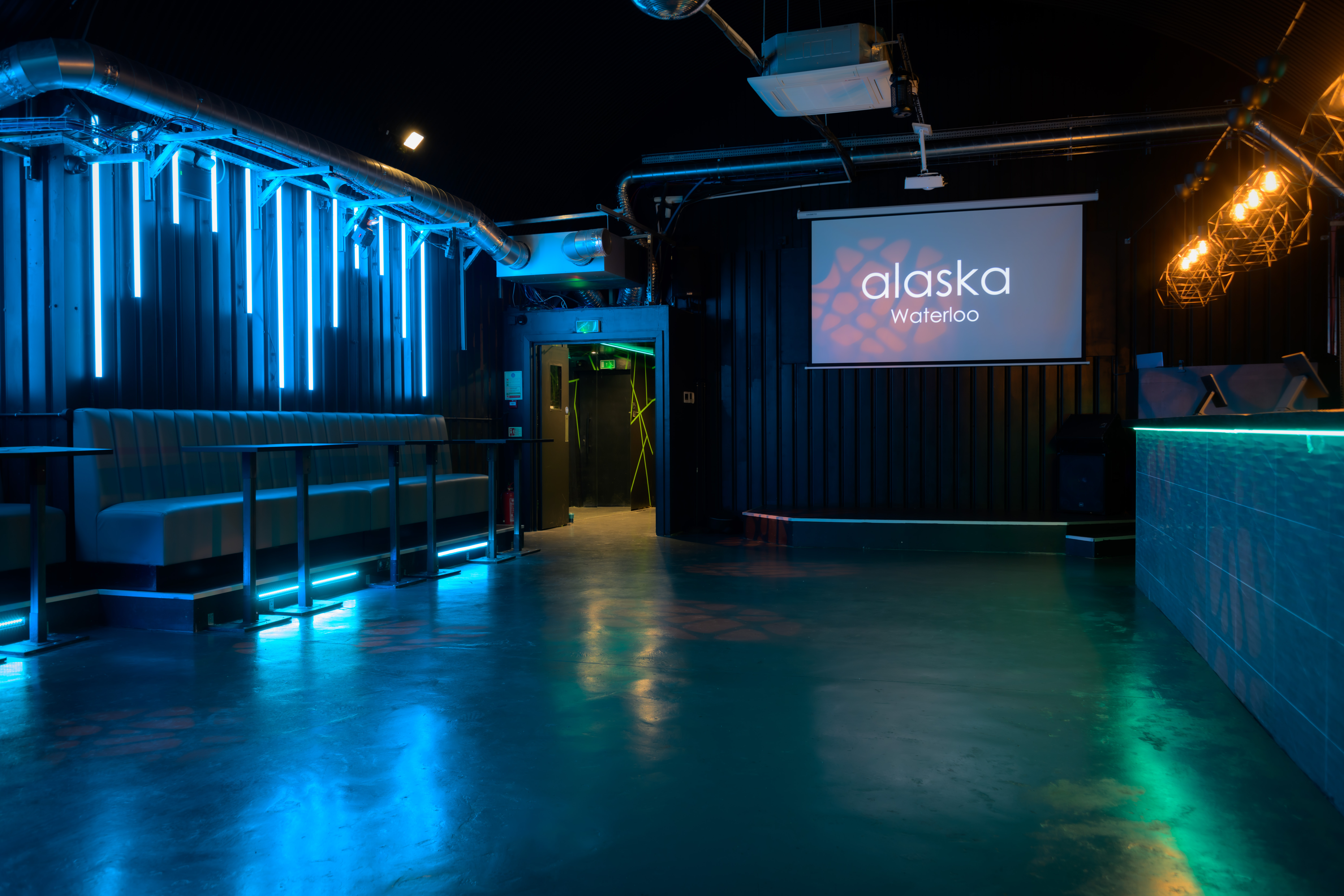 Modern event space in Alaska with blue lighting, perfect for networking and corporate meetings.