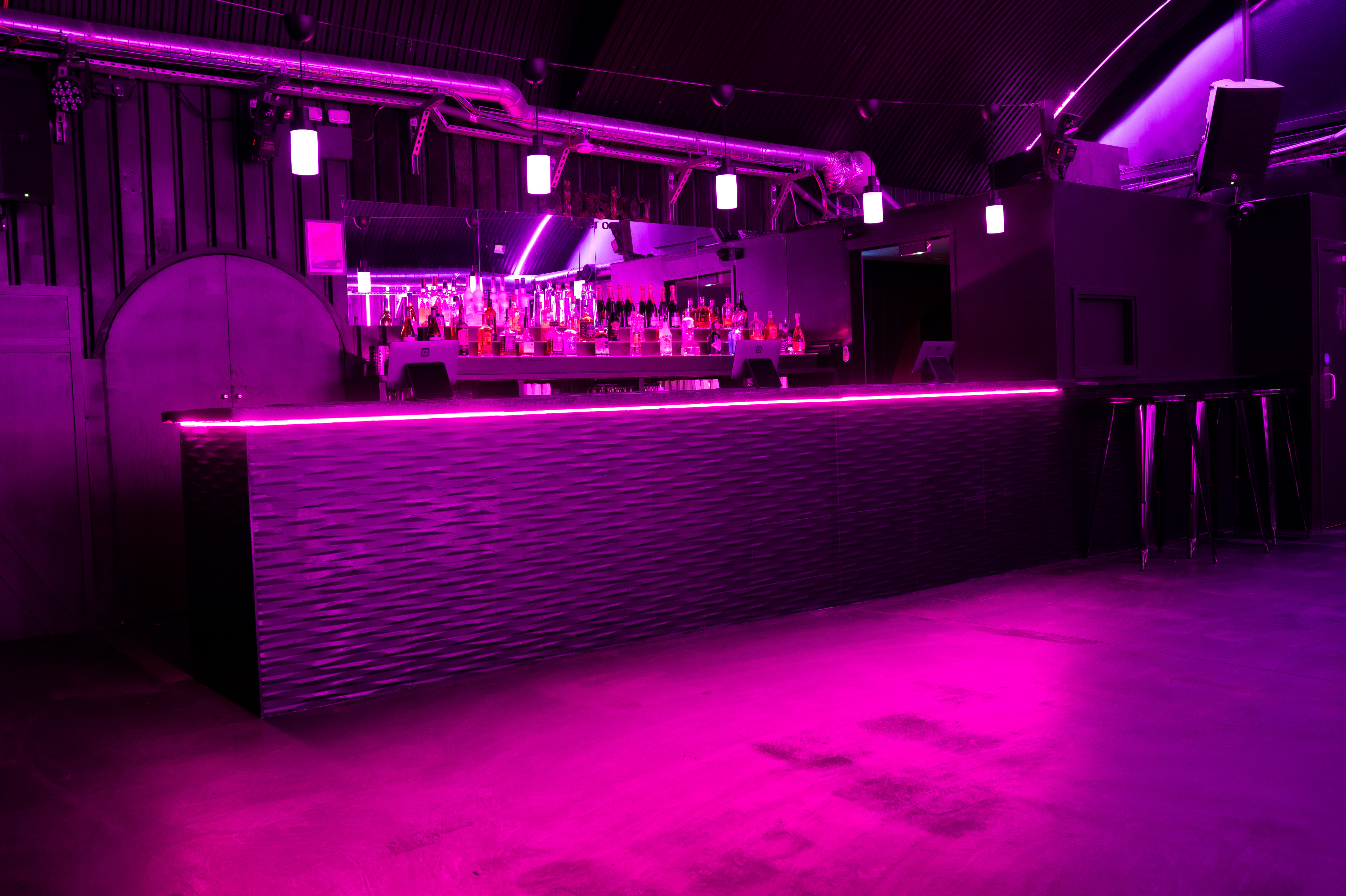 Modern bar with purple lighting in Alaska, perfect for evening events and celebrations.