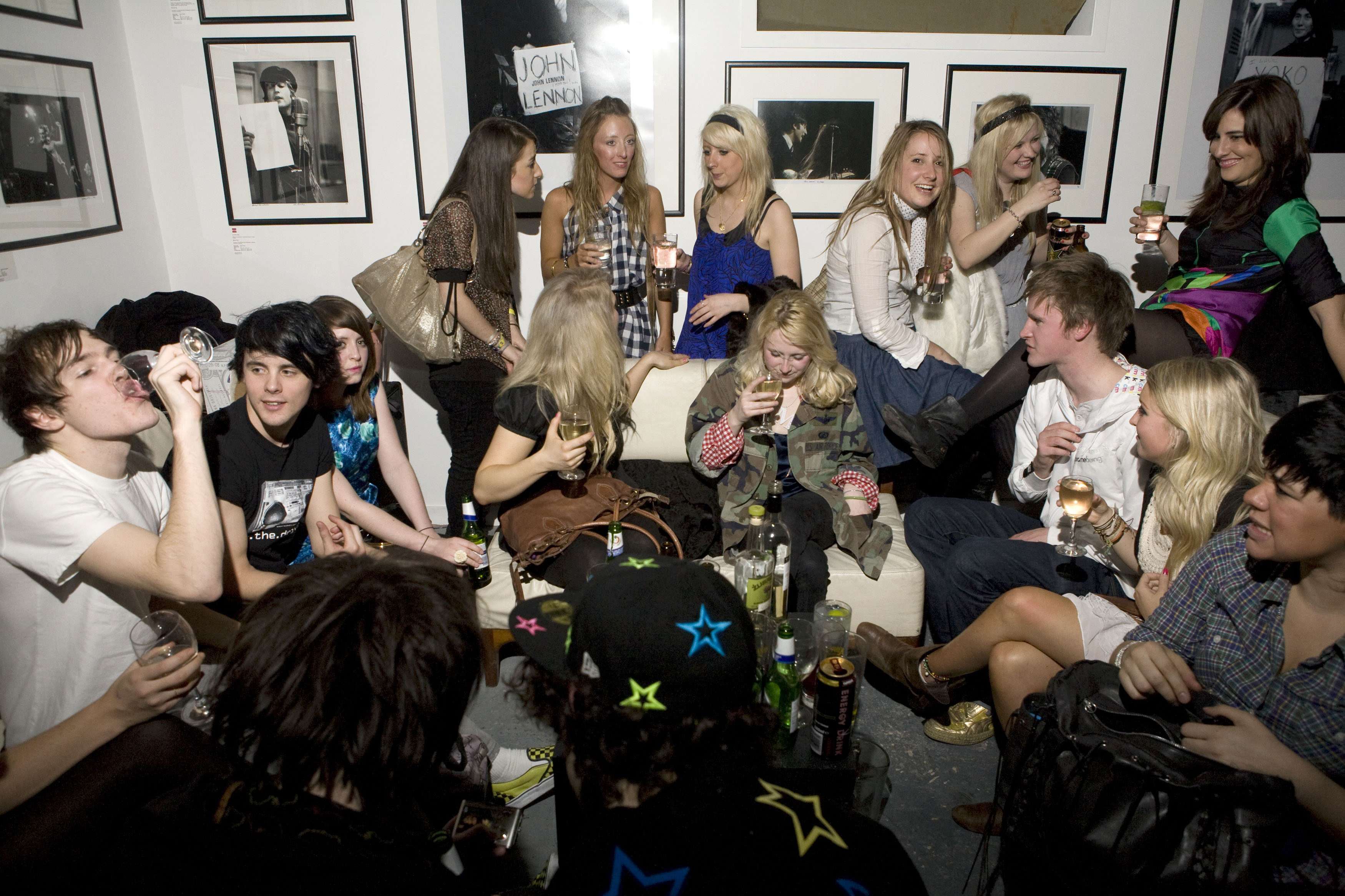 Lively networking event at Proud Galleries with stylish decor and drinks.