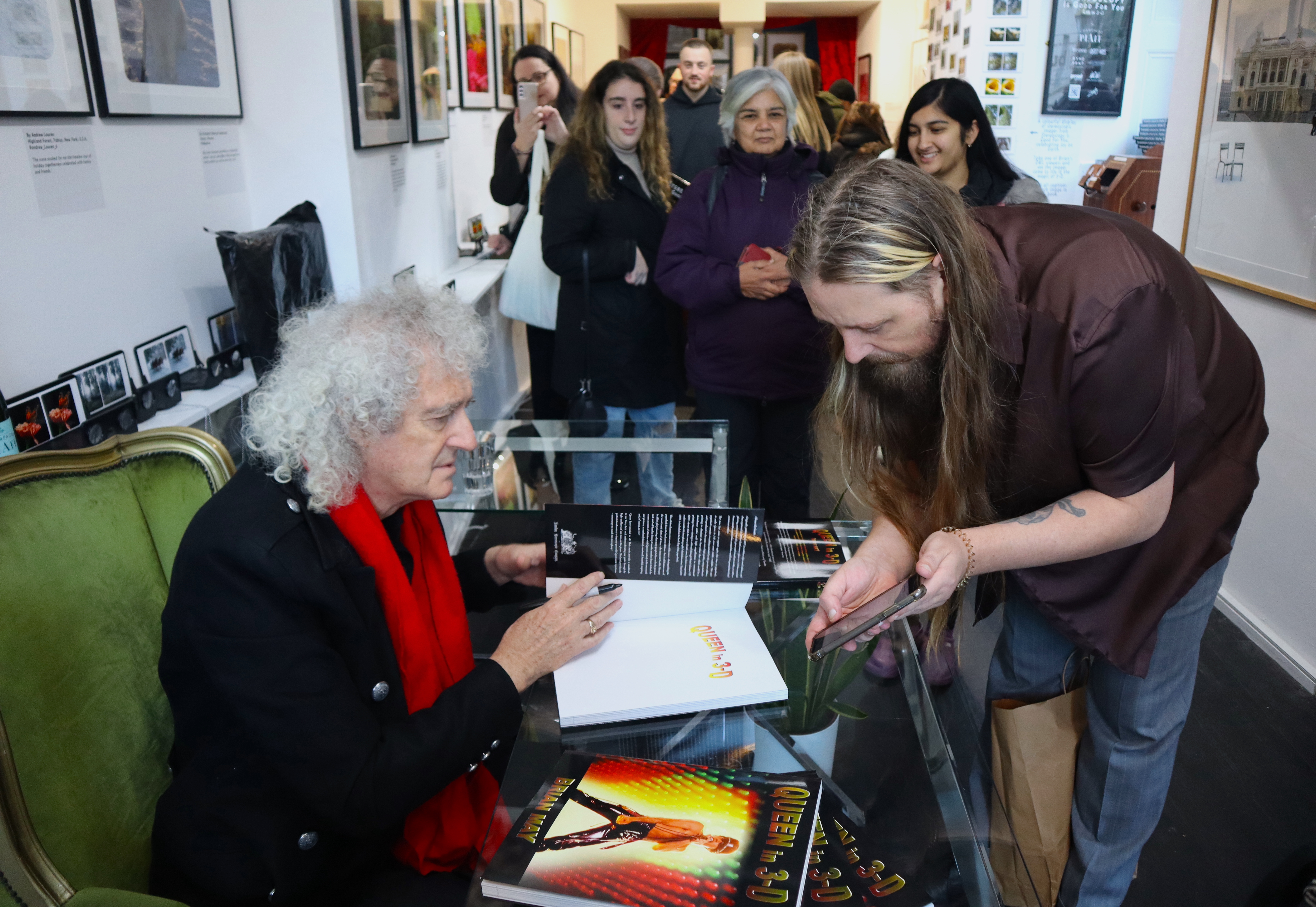 Vibrant book signing event at Proud Galleries with engaging author interaction.