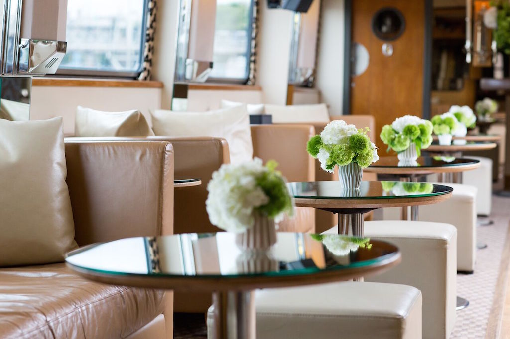 Silver Barracuda lounge with elegant floral arrangements for networking events.