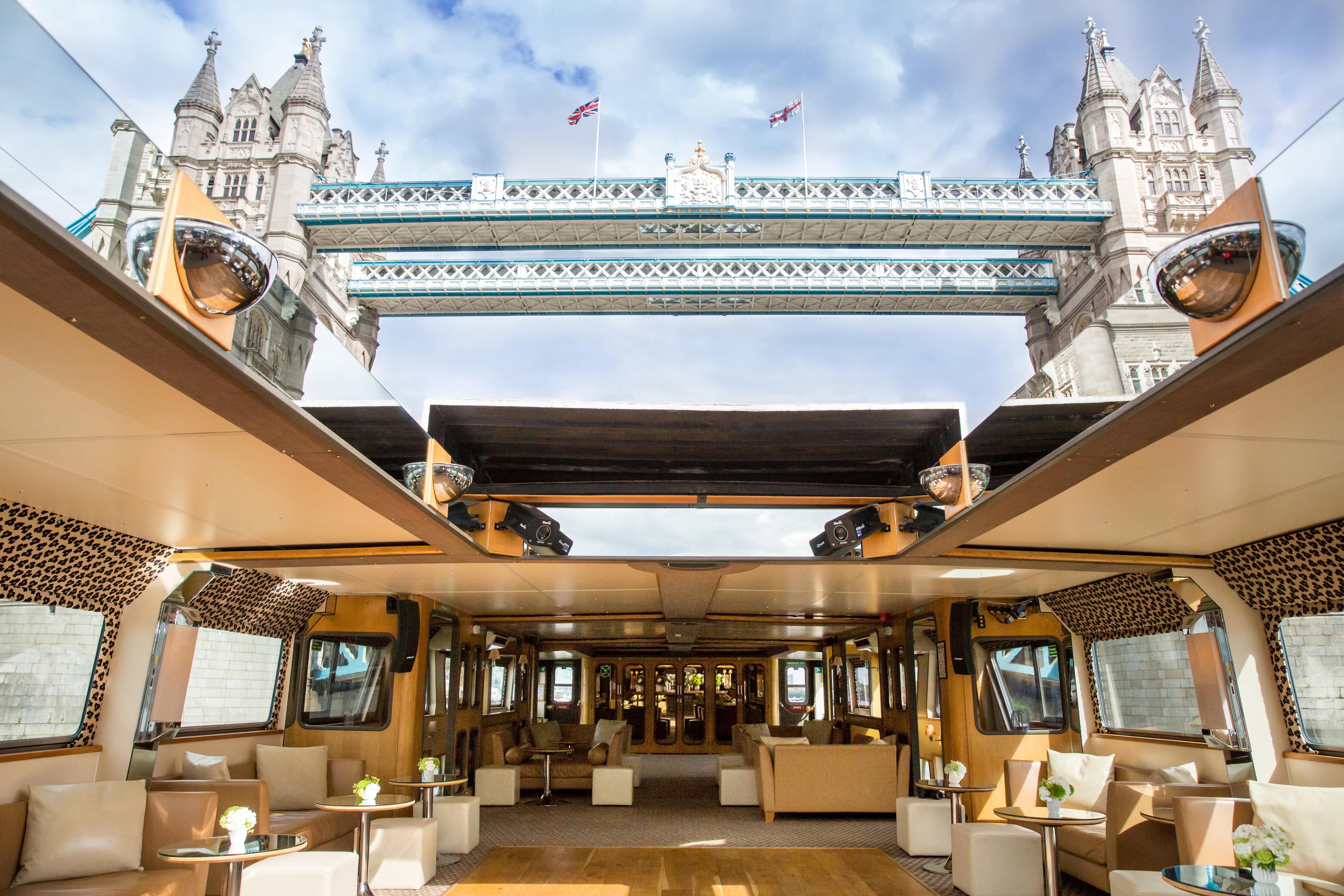 Silver Barracuda boat event space with elegant seating and Tower Bridge backdrop.