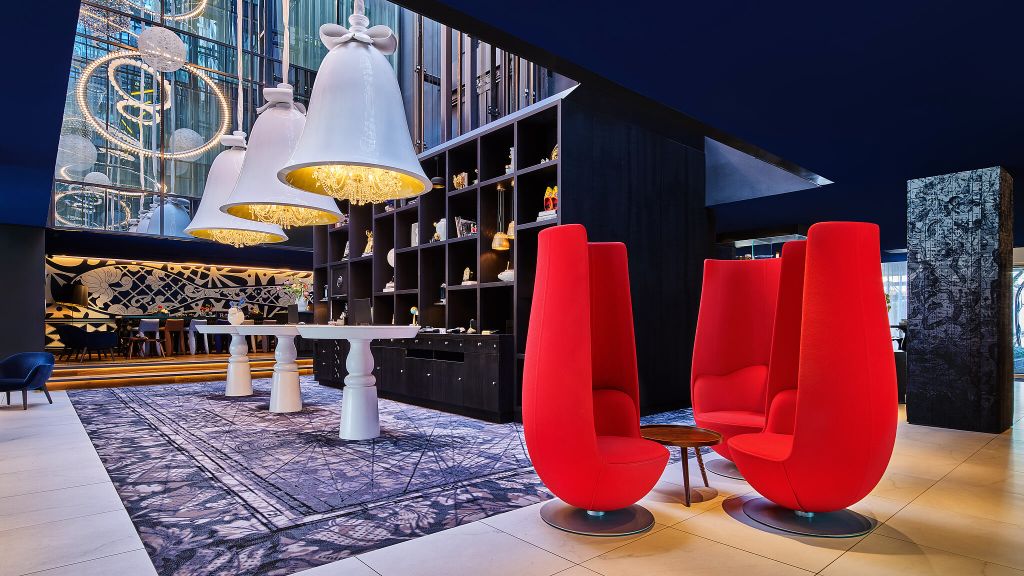 Delft Blue Room at Andaz Amsterdam with red seating for creative events and networking.