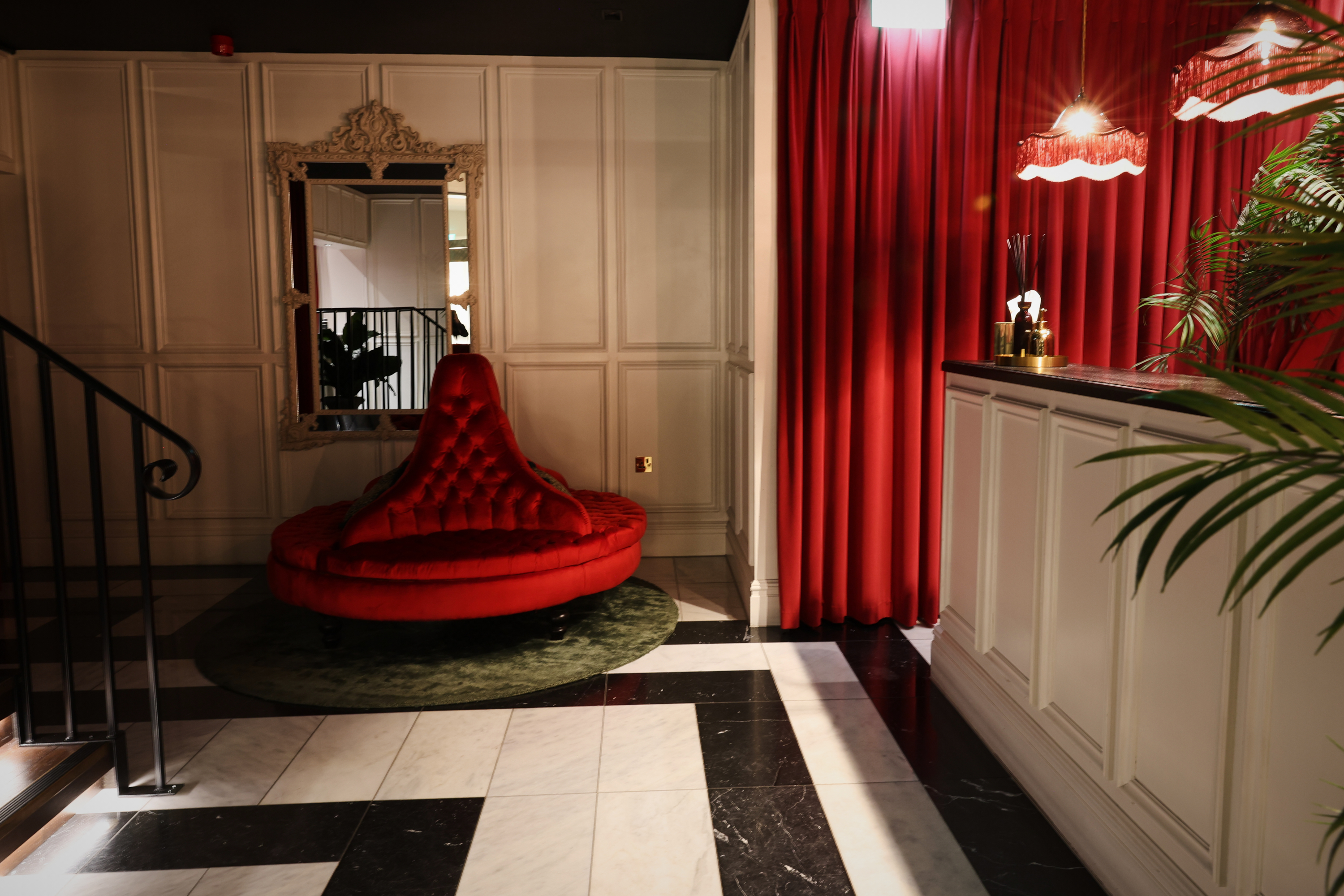 Stylish lobby at The Bar, featuring plush red seating for elegant events and gatherings.