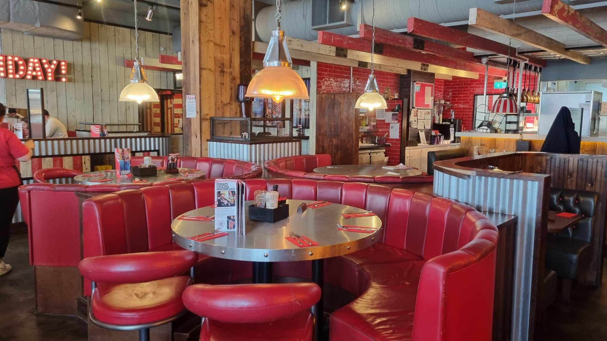 Vibrant TGI Friday's Brighton Marina venue with cozy red booths for networking events.
