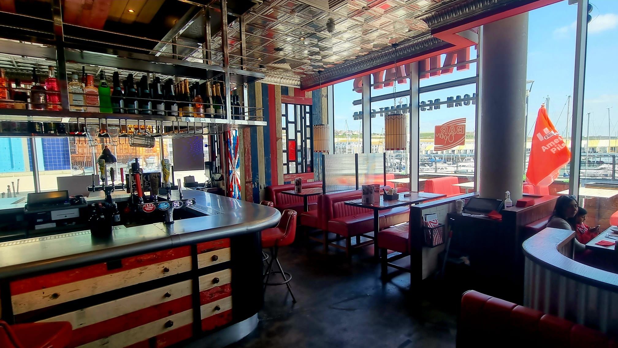 Vibrant bar area at TGI Friday's Brighton Marina, ideal for networking events and gatherings.