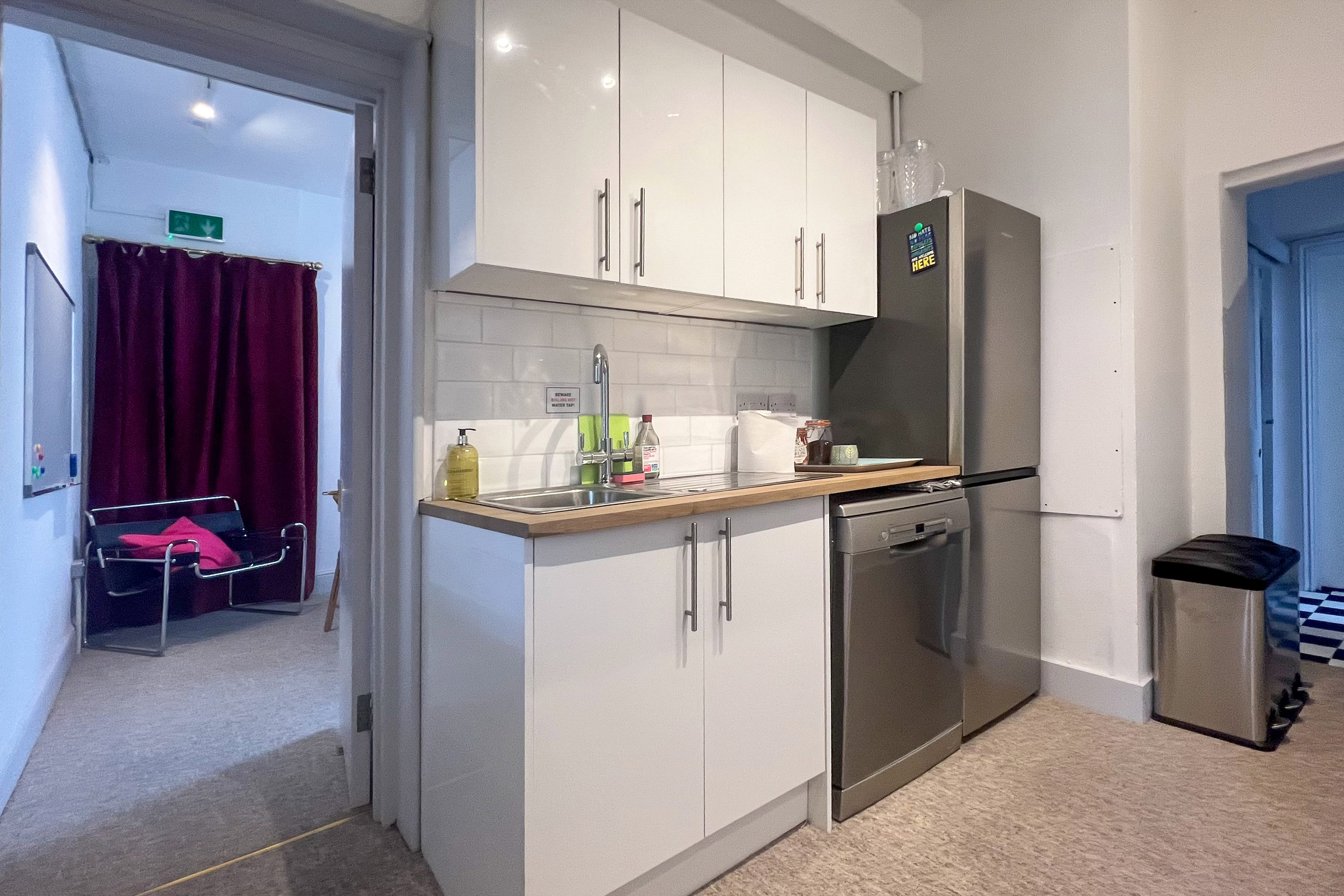Compact kitchenette in The Flat, Anomalous Space, ideal for event catering and gatherings.