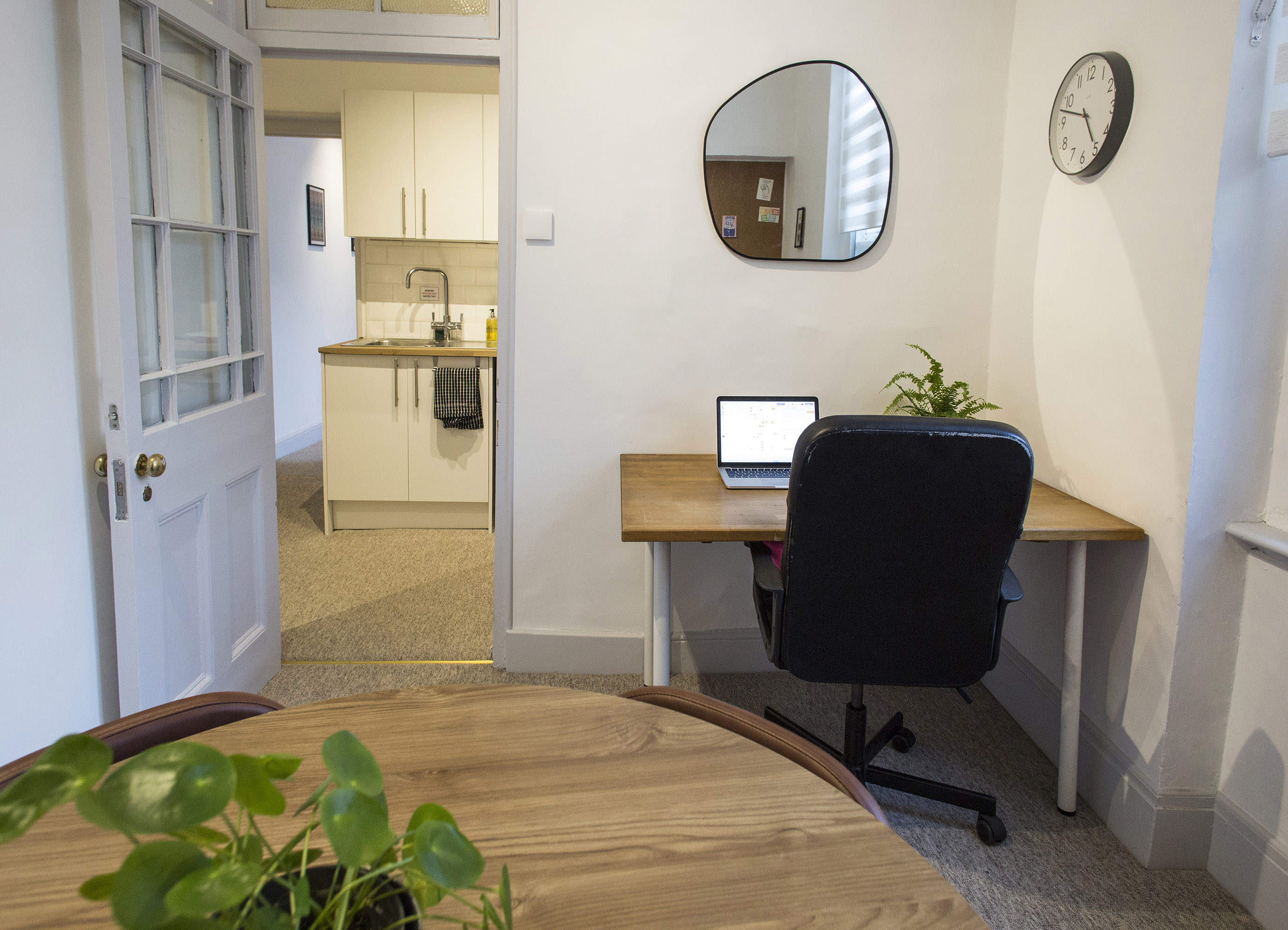 Cozy minimalist workspace with natural light for meetings and remote work.
