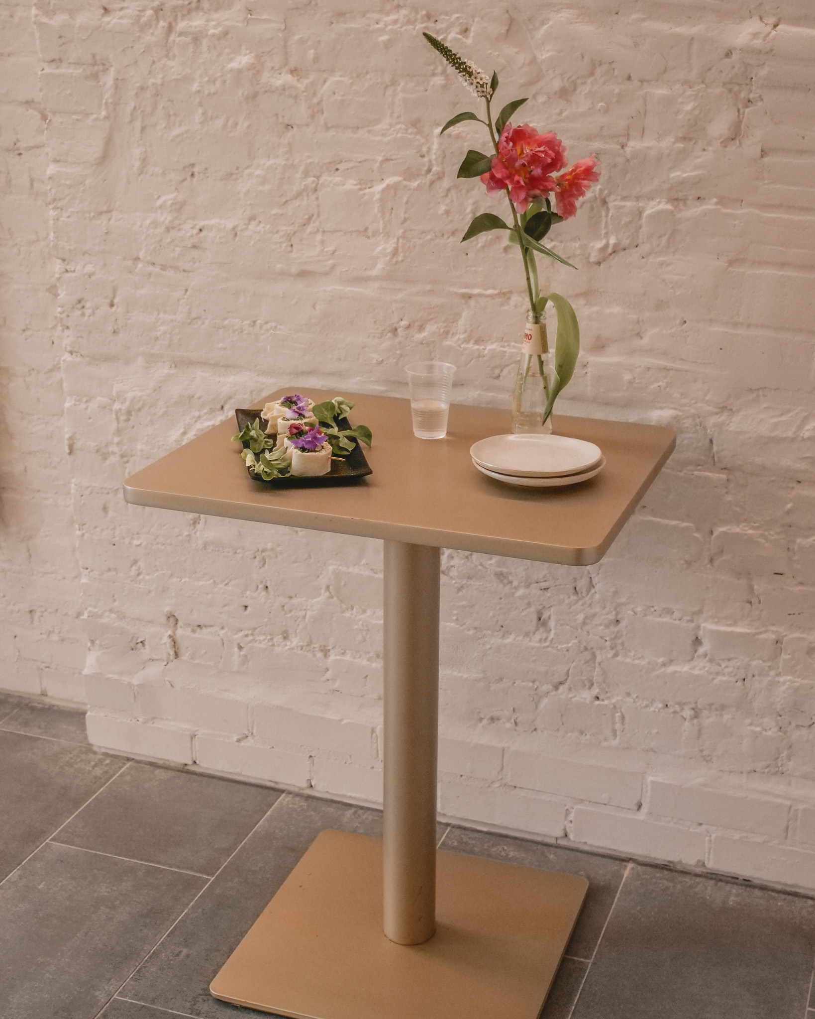 Minimalist event setup at Sunrise Studio with elegant table and floral arrangement.