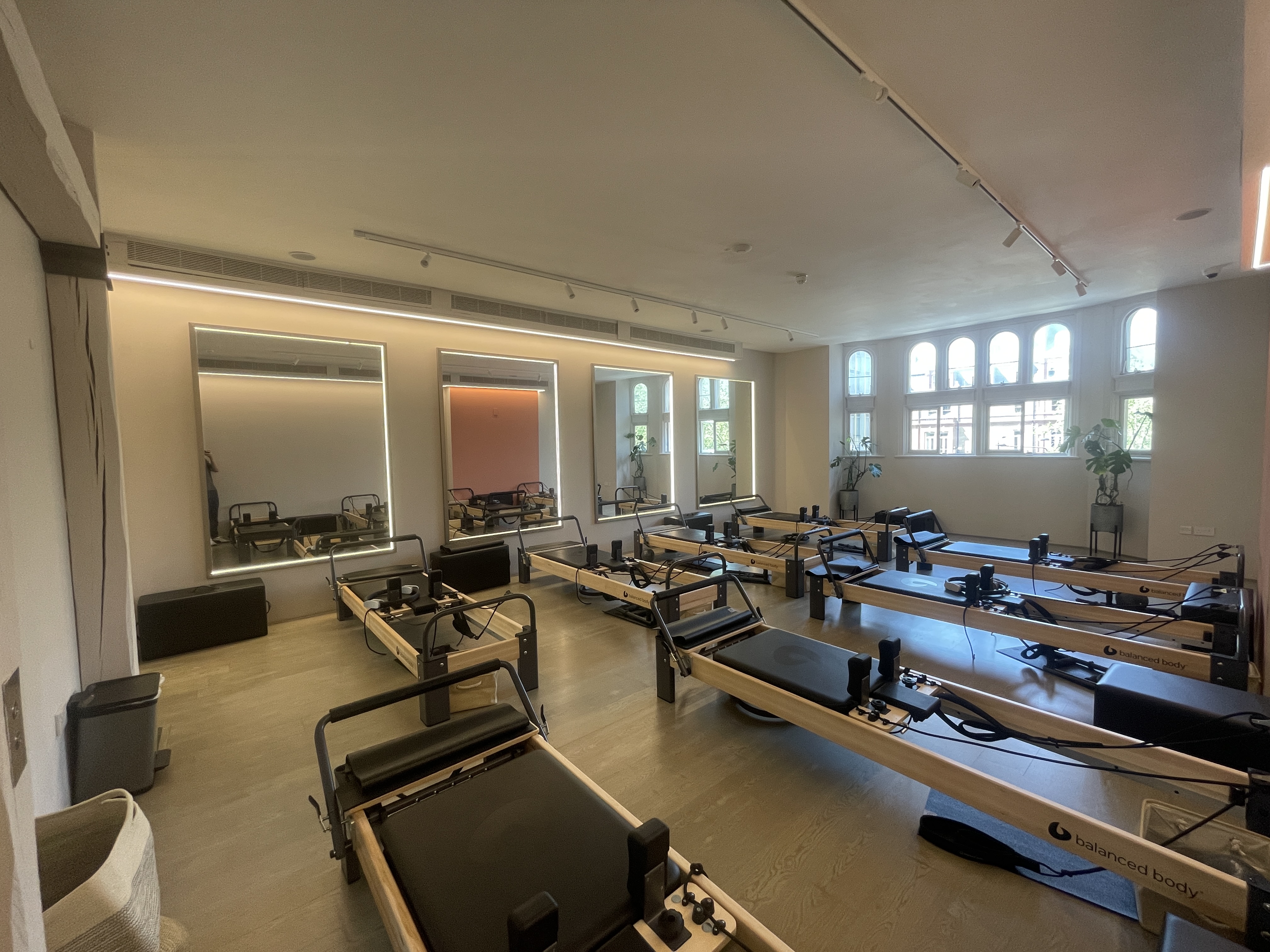 Modern fitness studio with reformer machines for wellness retreats and team-building events.