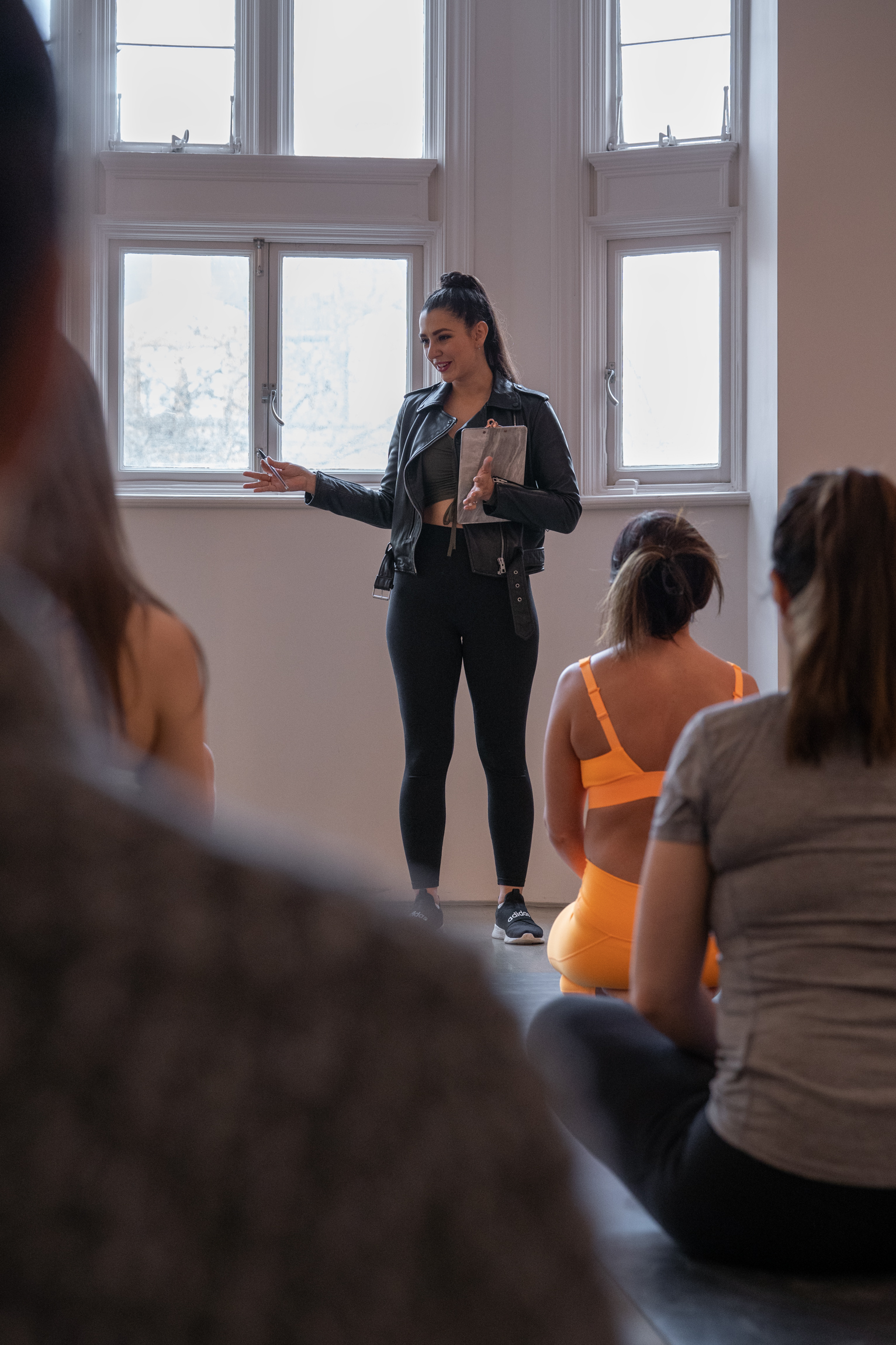 Dynamic speaker engaging audience in well-lit Bliss Studio for impactful workshops.