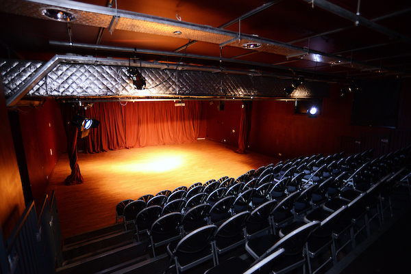 Versatile Oxford House theatre with well-lit stage for workshops and performances.