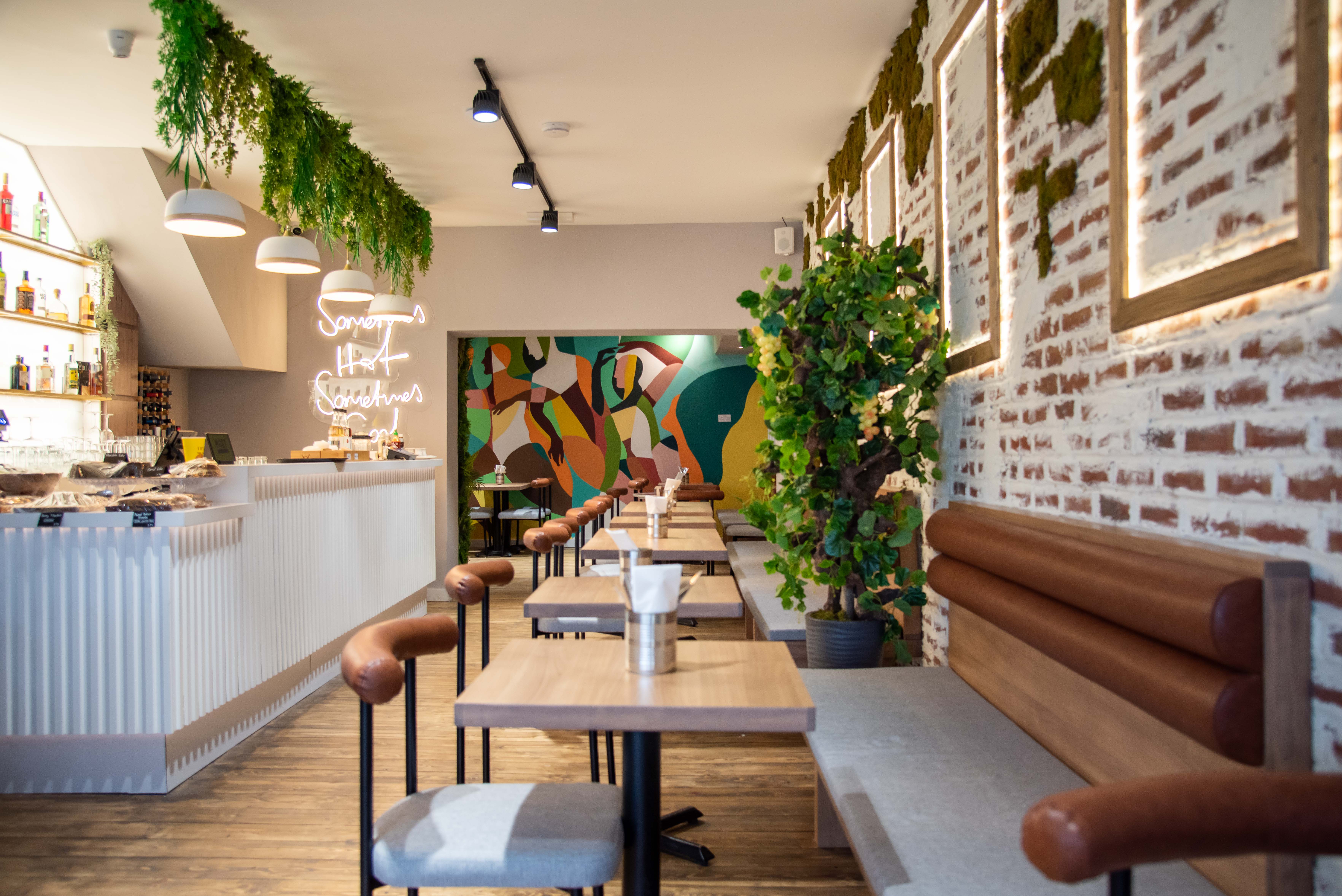 Modern venue with greenery and warm lighting for intimate gatherings and networking events.