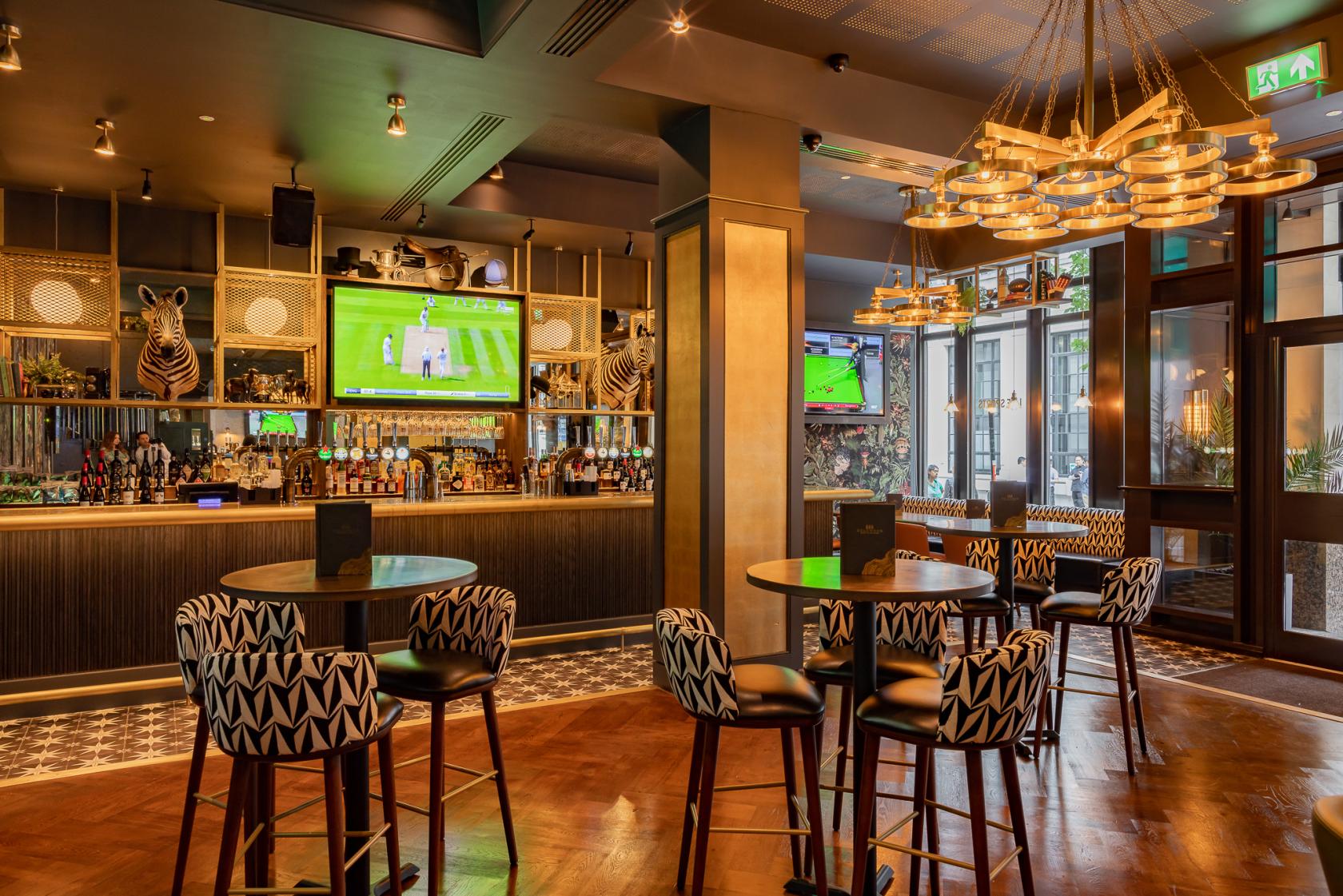 Stylish bar area at Goldwood Spots Pub for networking events and informal meetings.