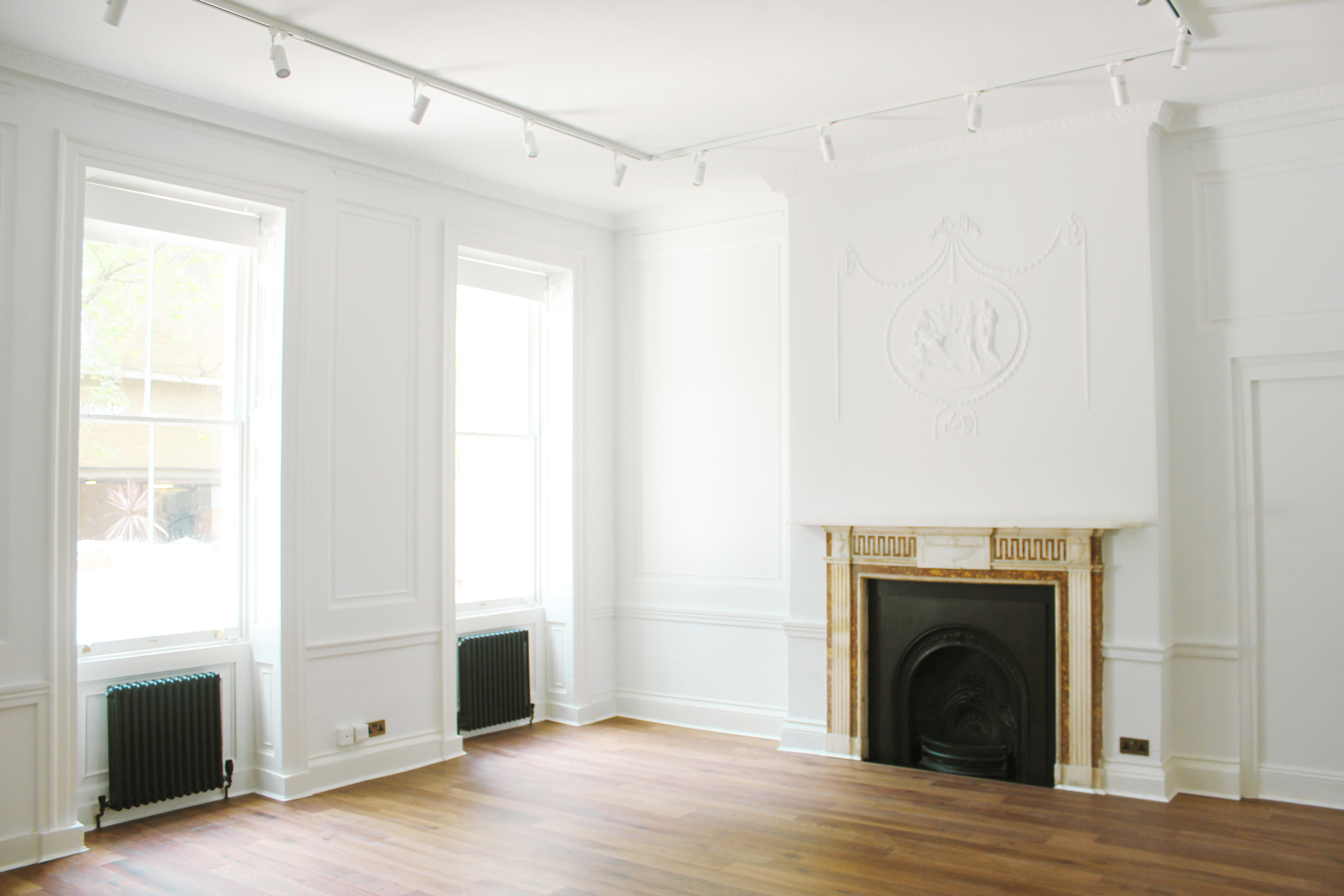 Versatile event space at 34 Bloomsbury with natural light and elegant fireplace.