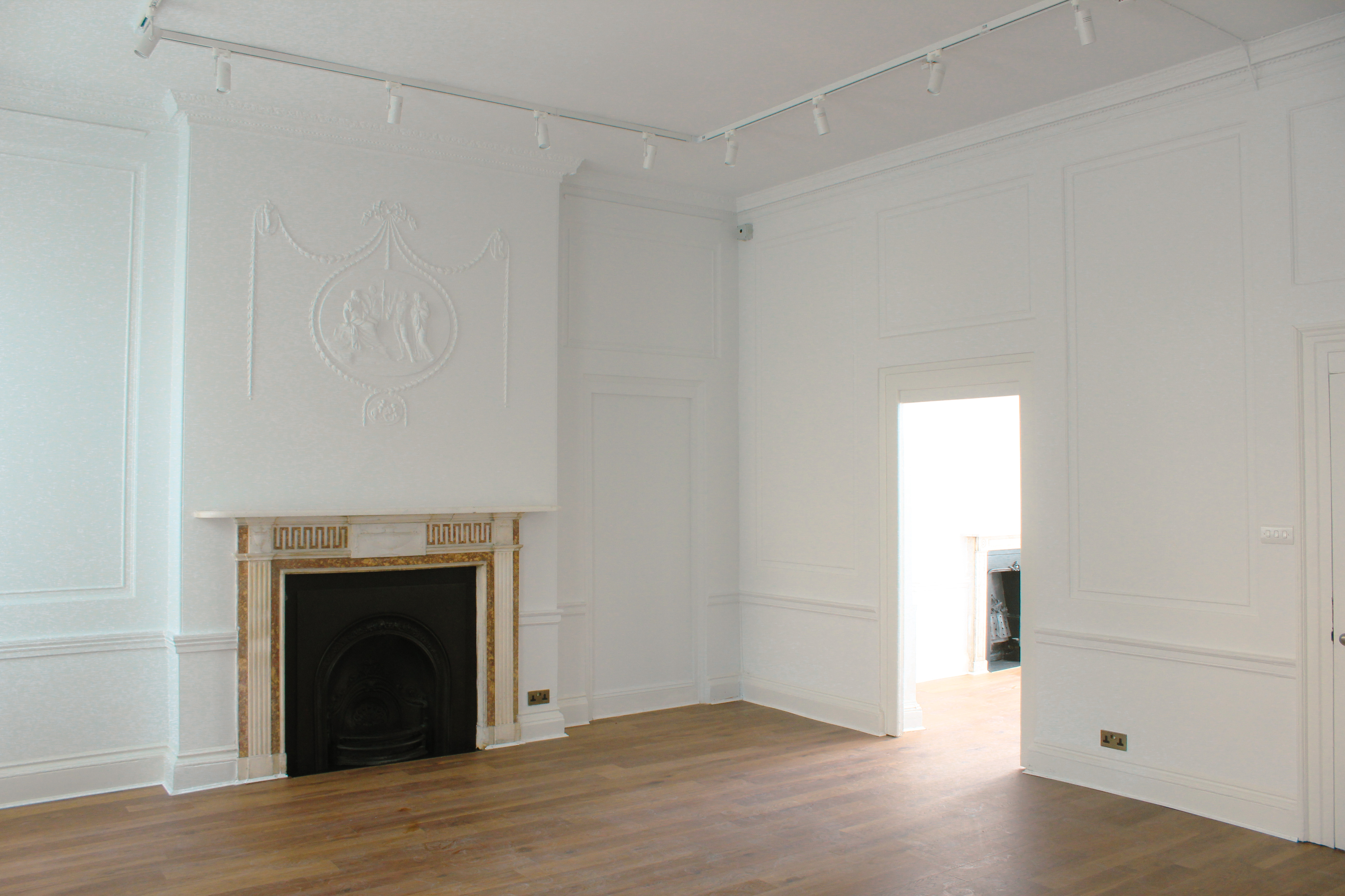 Versatile meeting space at 34 Bloomsbury with elegant fireplace for workshops and presentations.