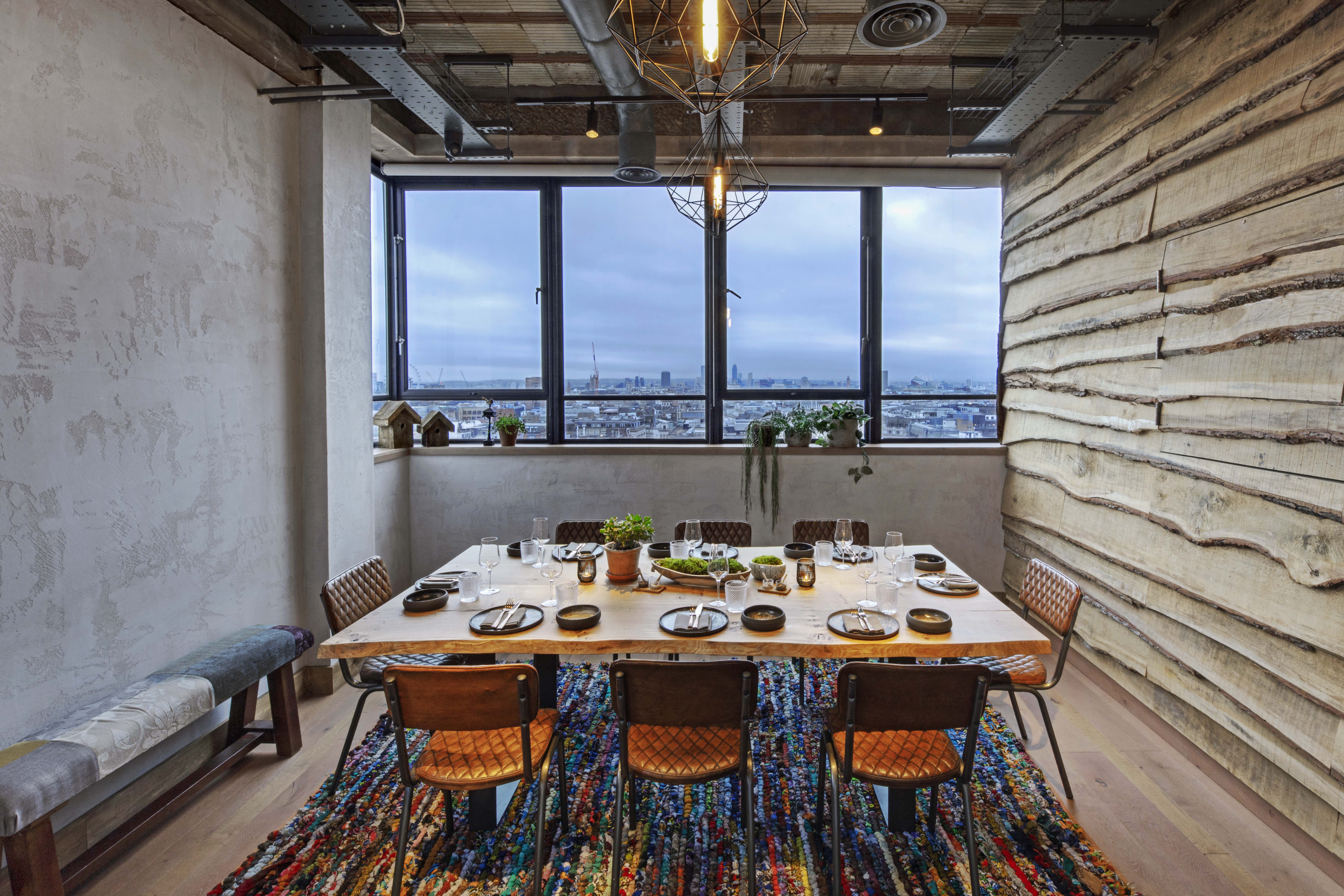 Stylish meeting space with wooden table at The Treehouse Hotel for corporate retreats.