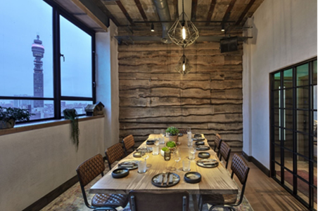 Stylish meeting space with wooden table at The Treehouse Hotel for corporate events.
