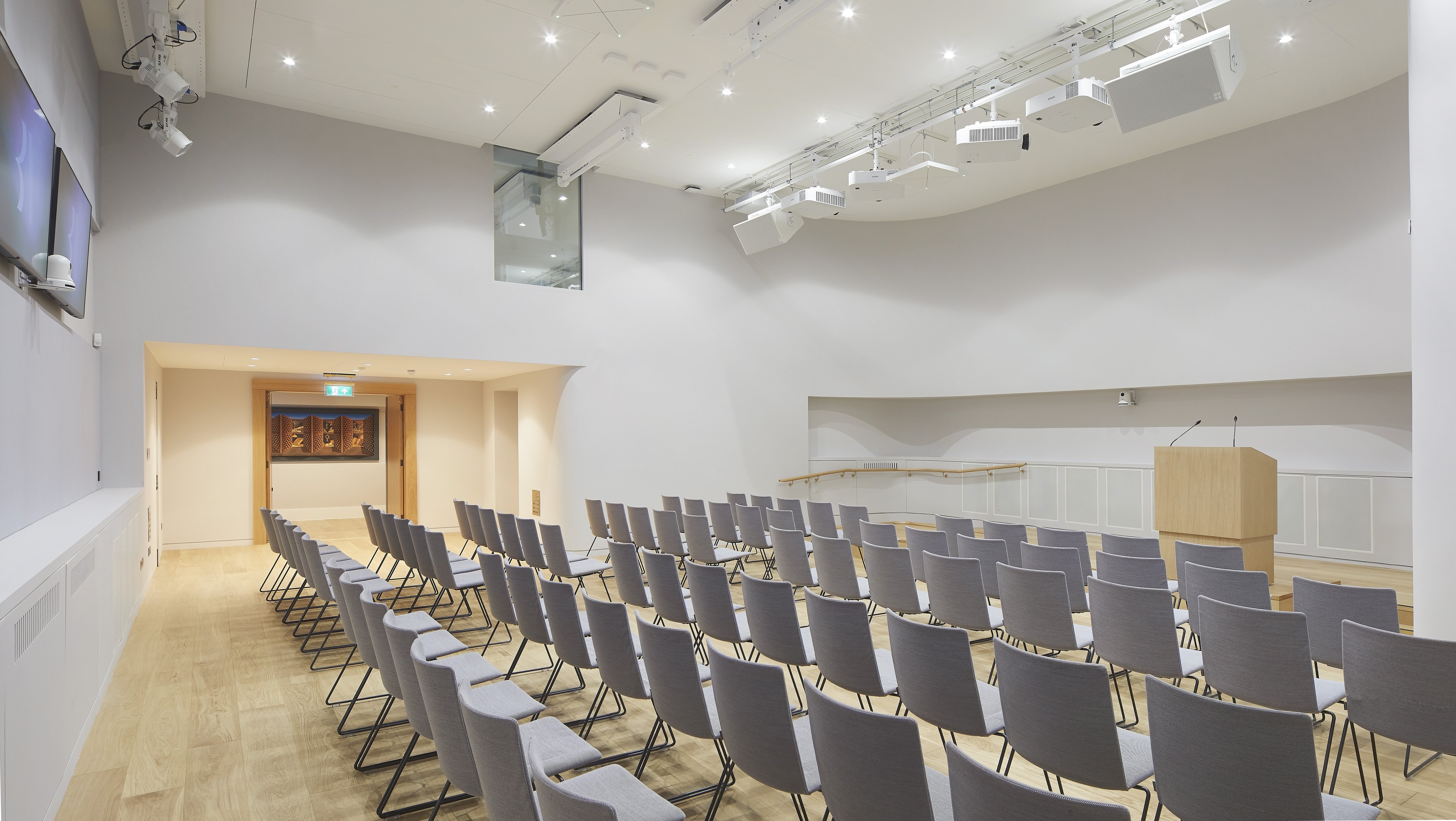 Modern meeting room with gray chairs, ideal for corporate events and workshops.