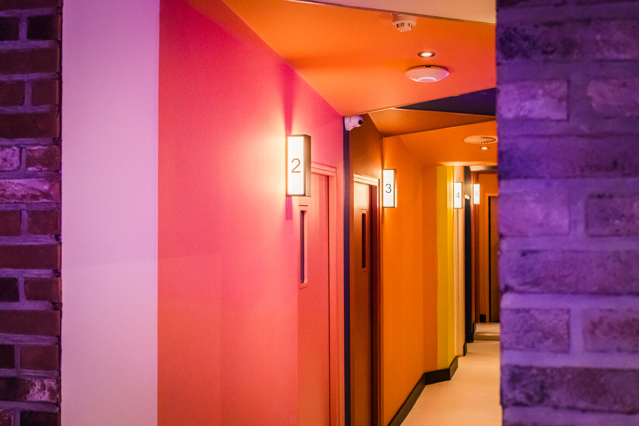 Private karaoke rooms with colorful walls at Lucky Voice Liverpool Street, perfect for events.