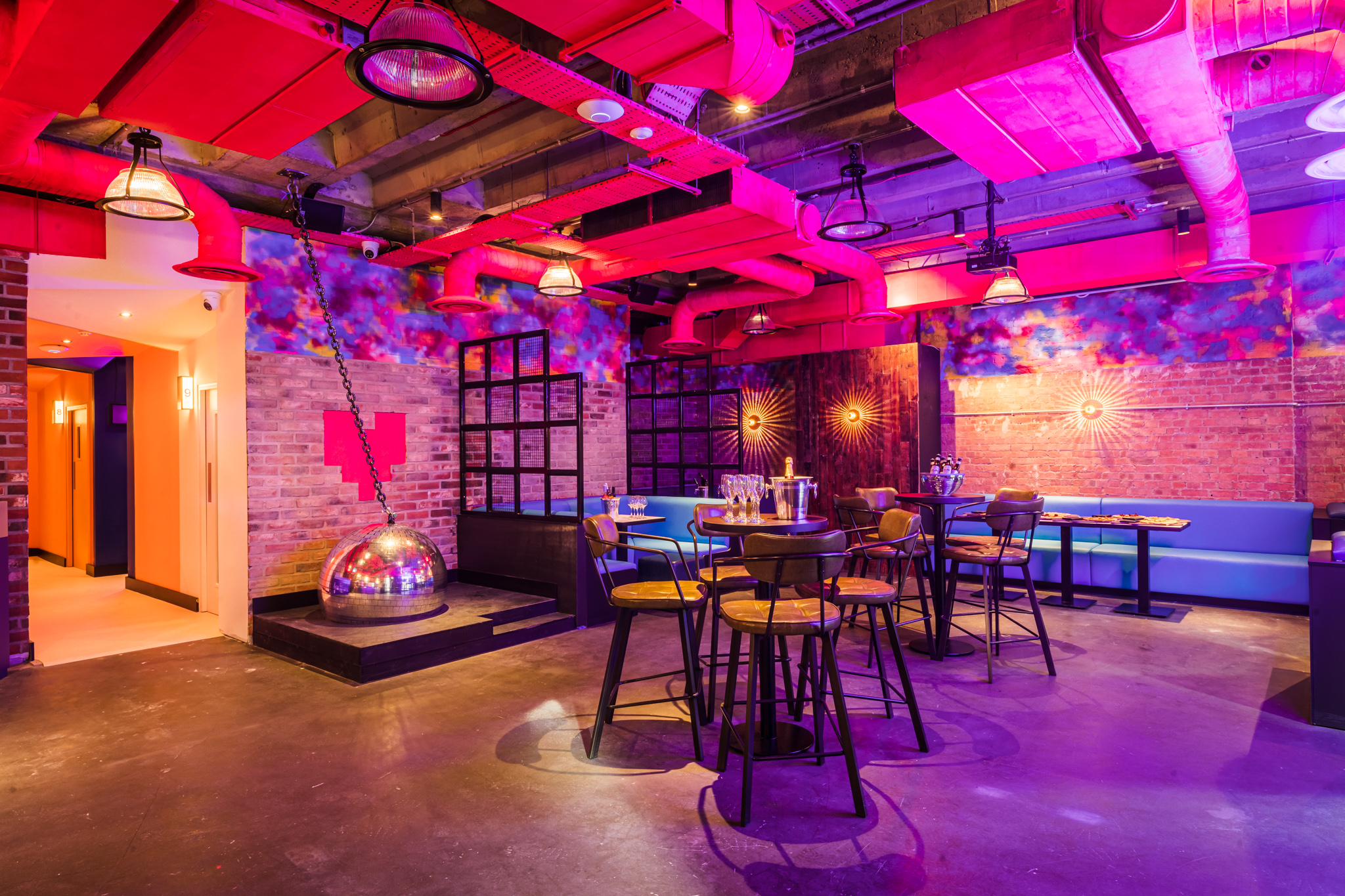 Private karaoke room with exposed brick walls, ideal for networking events and gatherings.