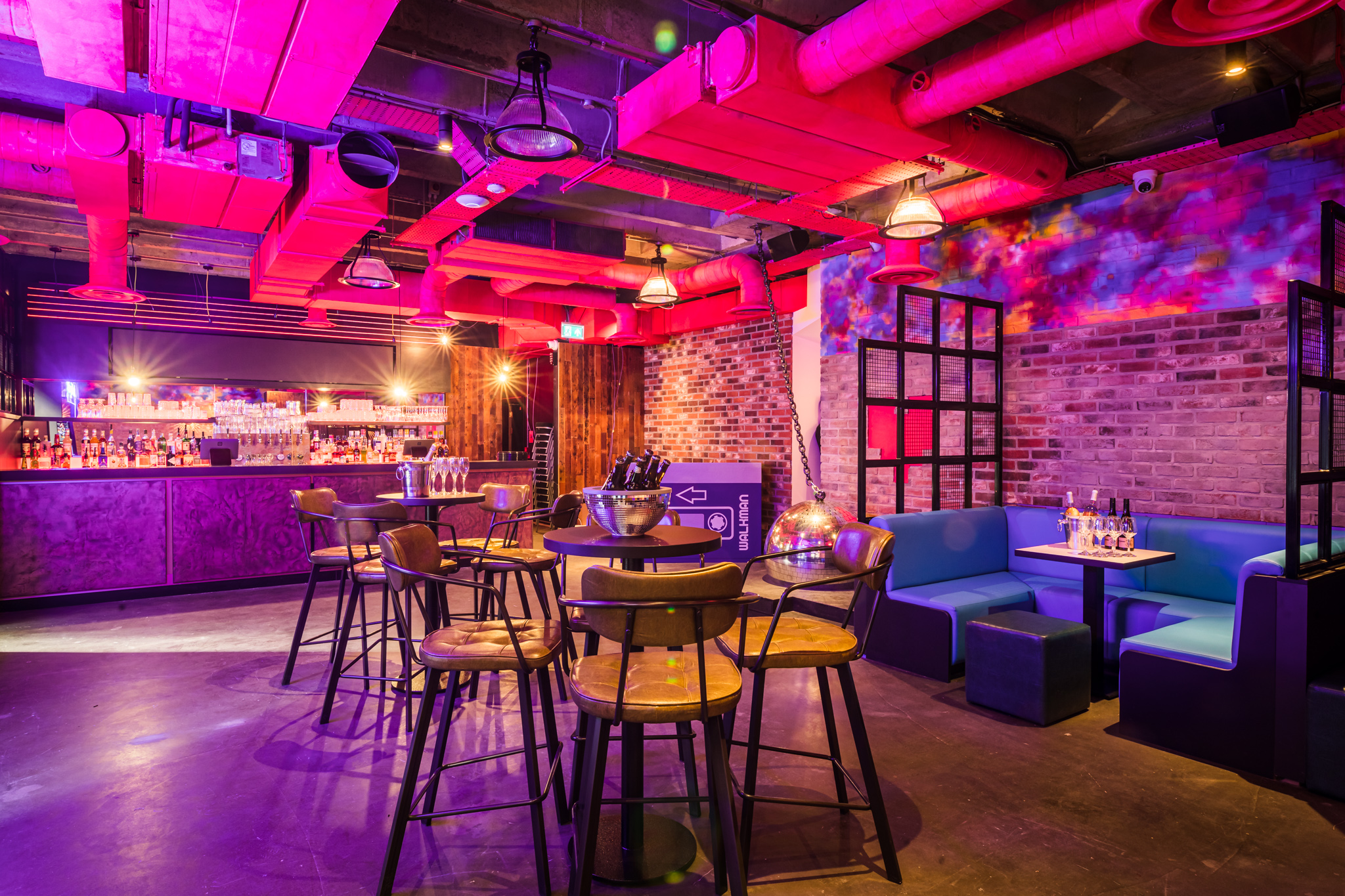 Private karaoke room with colorful lighting for social gatherings at Lucky Voice Liverpool Street.