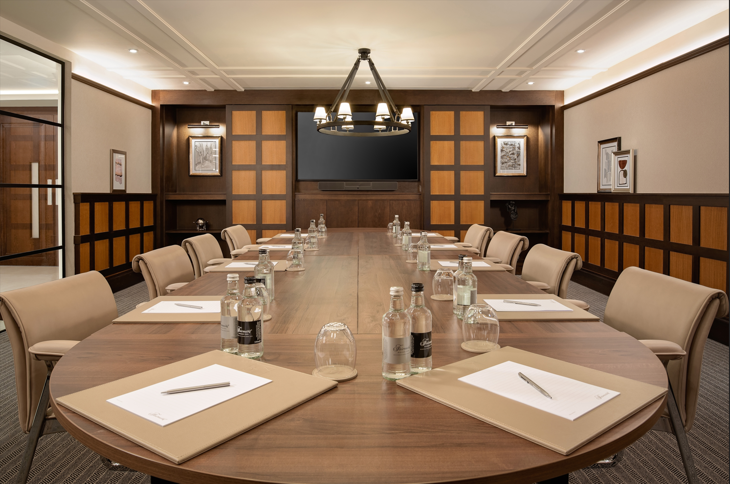 Elegant meeting room with oval table, ideal for professional gatherings and presentations.