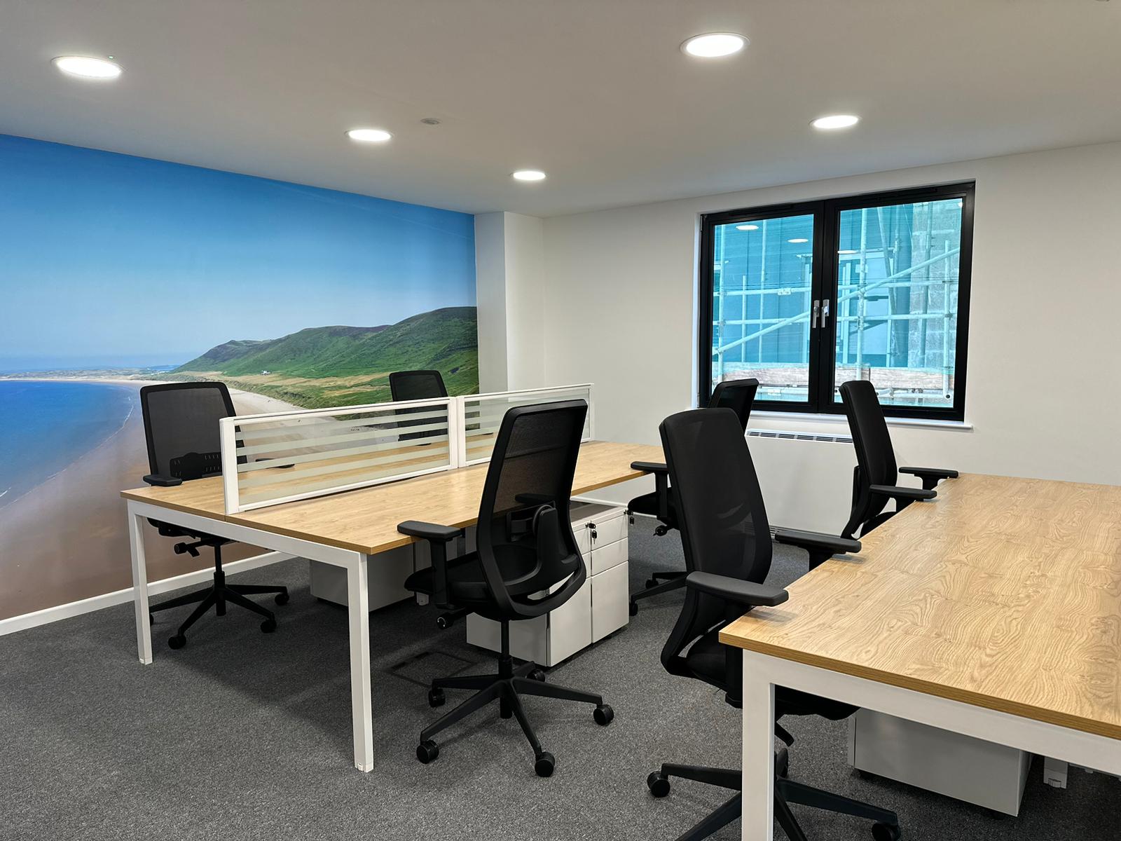 Modern hot desks in a bright office, ideal for meetings and workshops at St Andrews Place.
