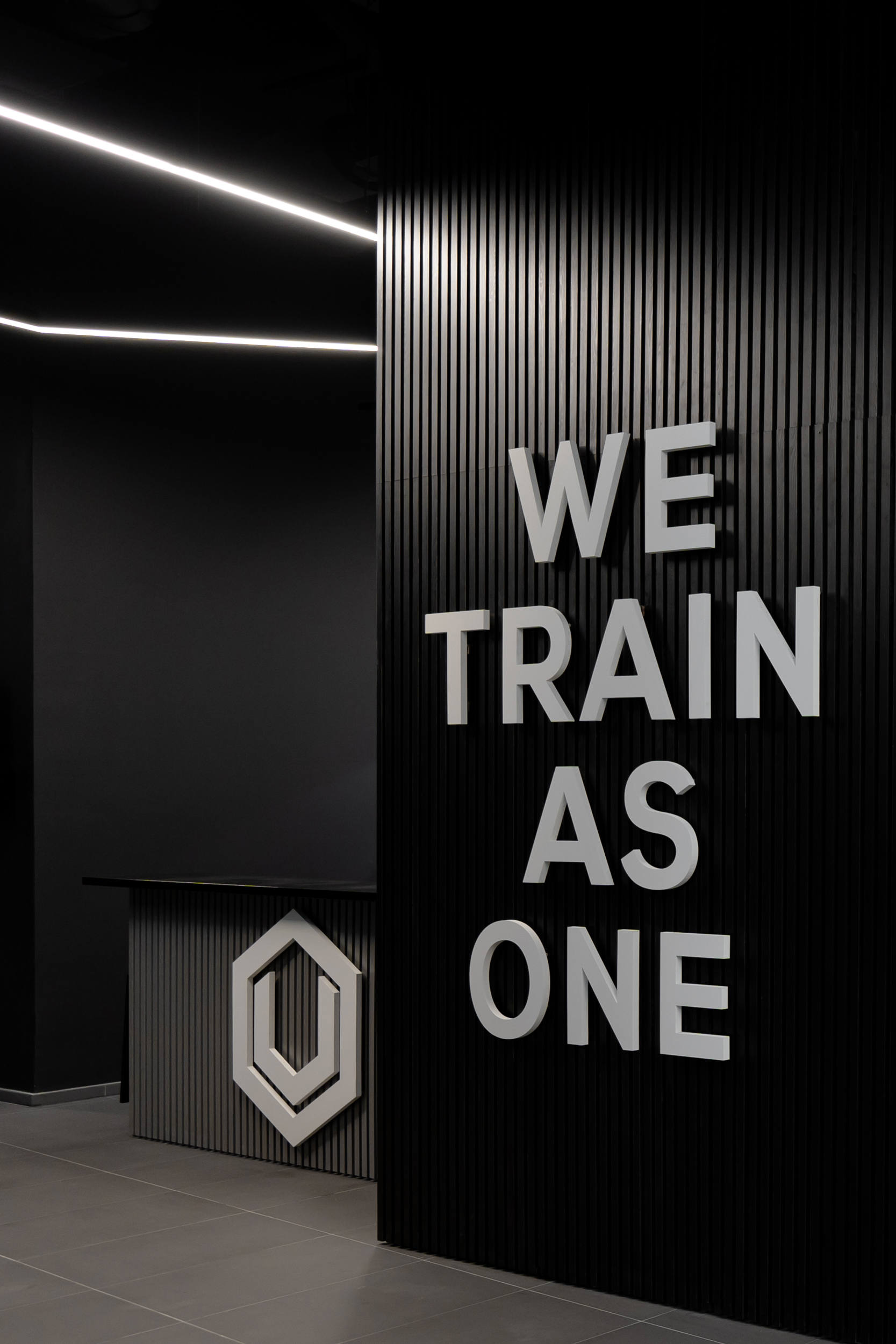 Premium Boutique Fitness Studio in South West London with "WE TRAIN AS ONE" slogan.