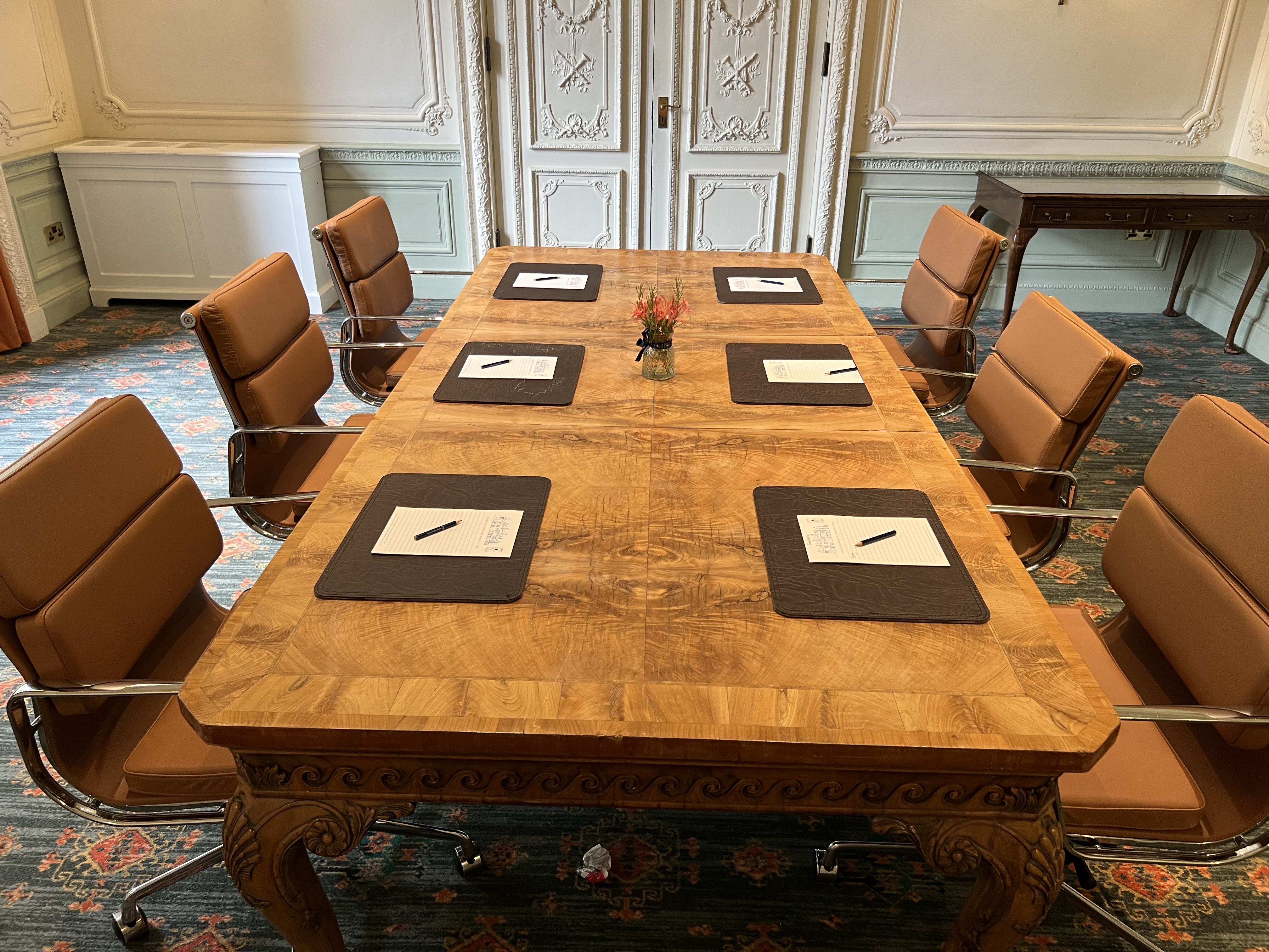 Lavender meeting room at Warren House Hotel with wooden table and leather chairs.