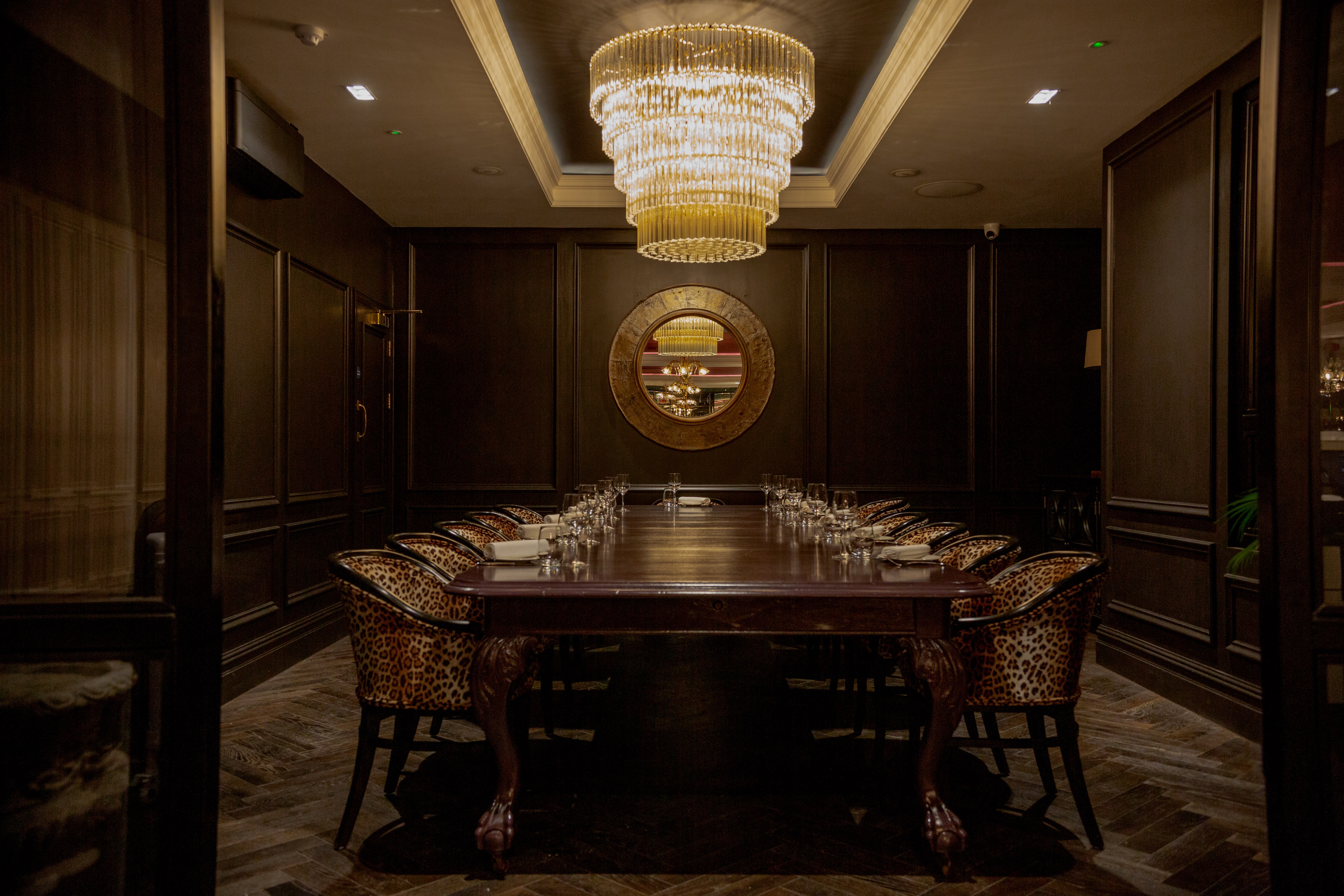 Elegant private dining room with chandelier for exclusive events and corporate dinners.